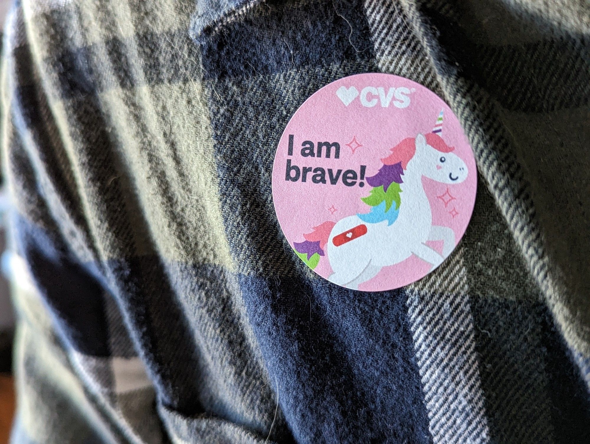 A sticker from CVS that says "I am brave!"