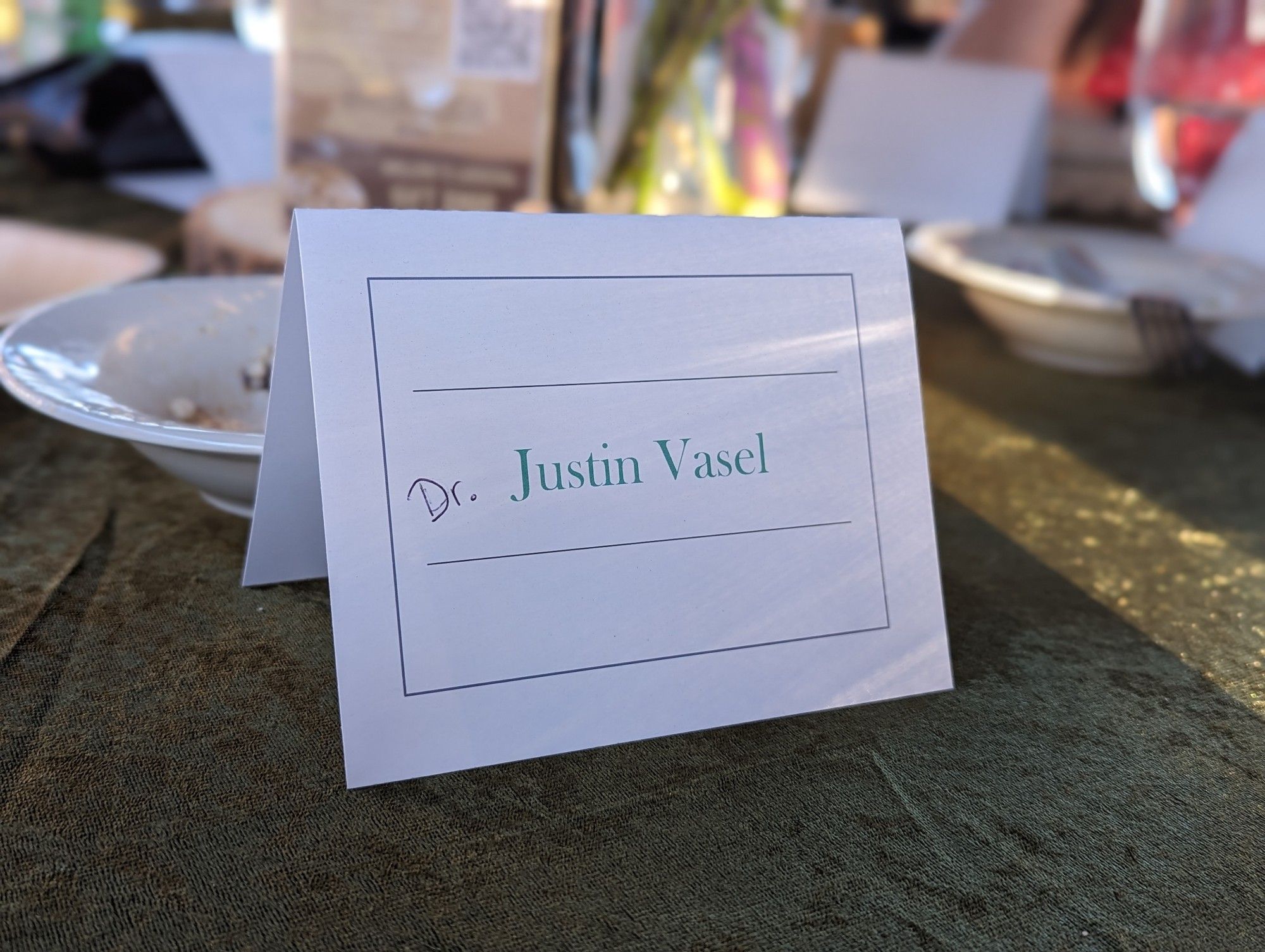 A name card at a wedding reception table with my name and the word Dr handwritten in