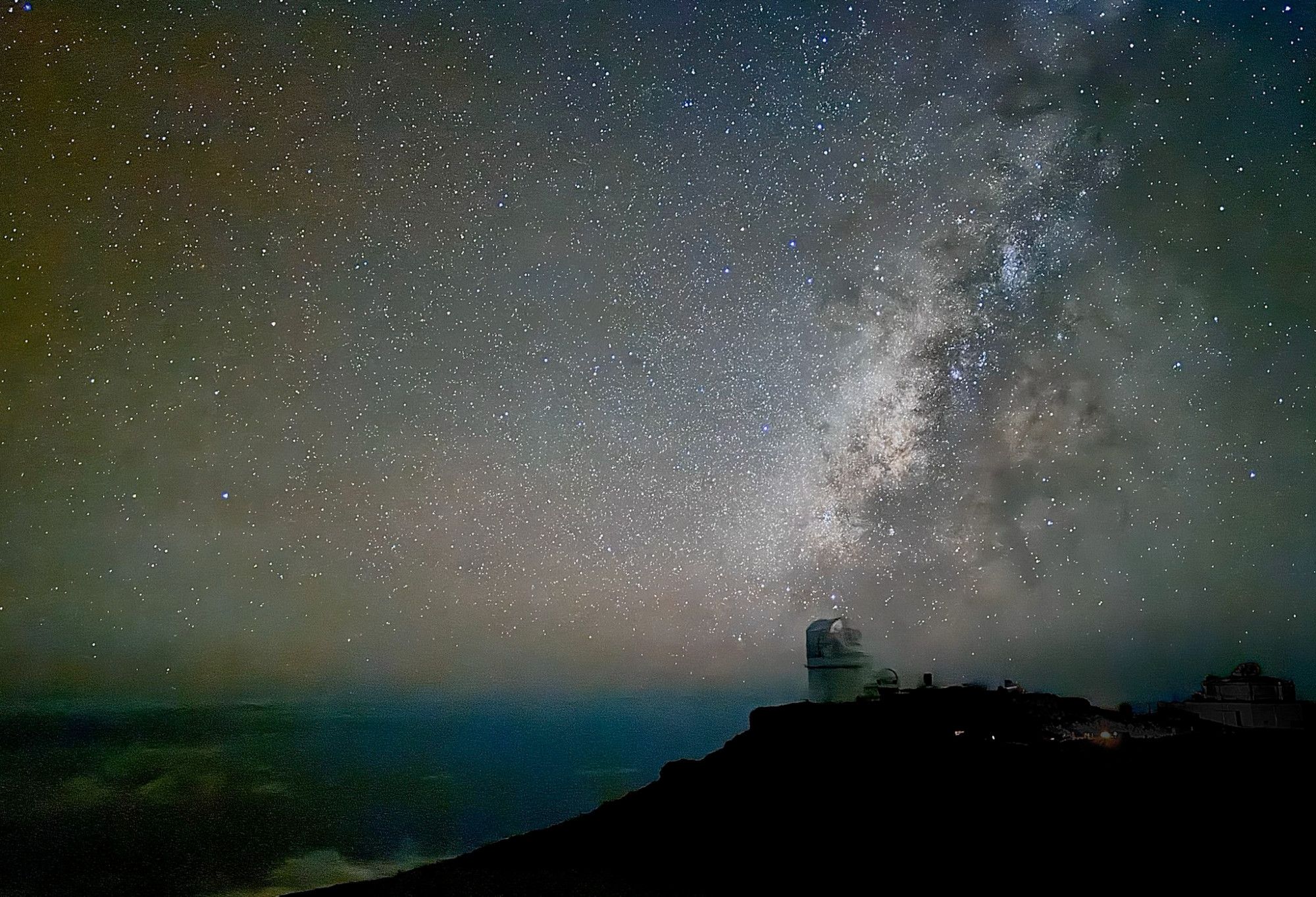 The glorious night sky stretches across the image taken on the summit of Haleakalā on the island of Maui.  The dusty dark lanes of our galaxy are silhouetted by the glow of vast numbers of stars in the galactic plane. In the image foreground is the dome of the Daniel K. Inouye Solar Telescope,  the largest and most advanced solar telescope in the world, along with a few other telescope domes.