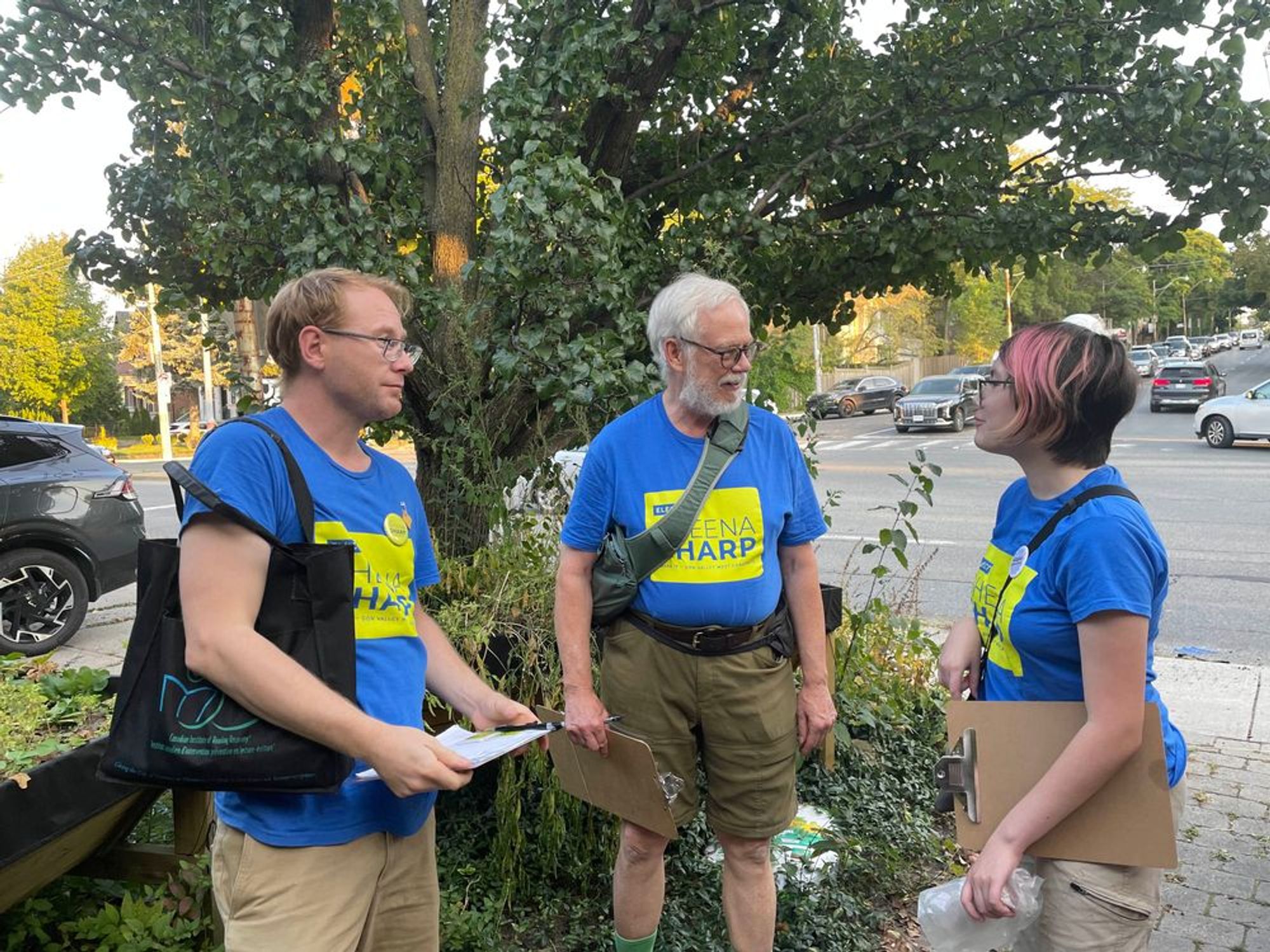 Canvassers for Sheena Sharp walking around the neighbourhood holding clipboards.