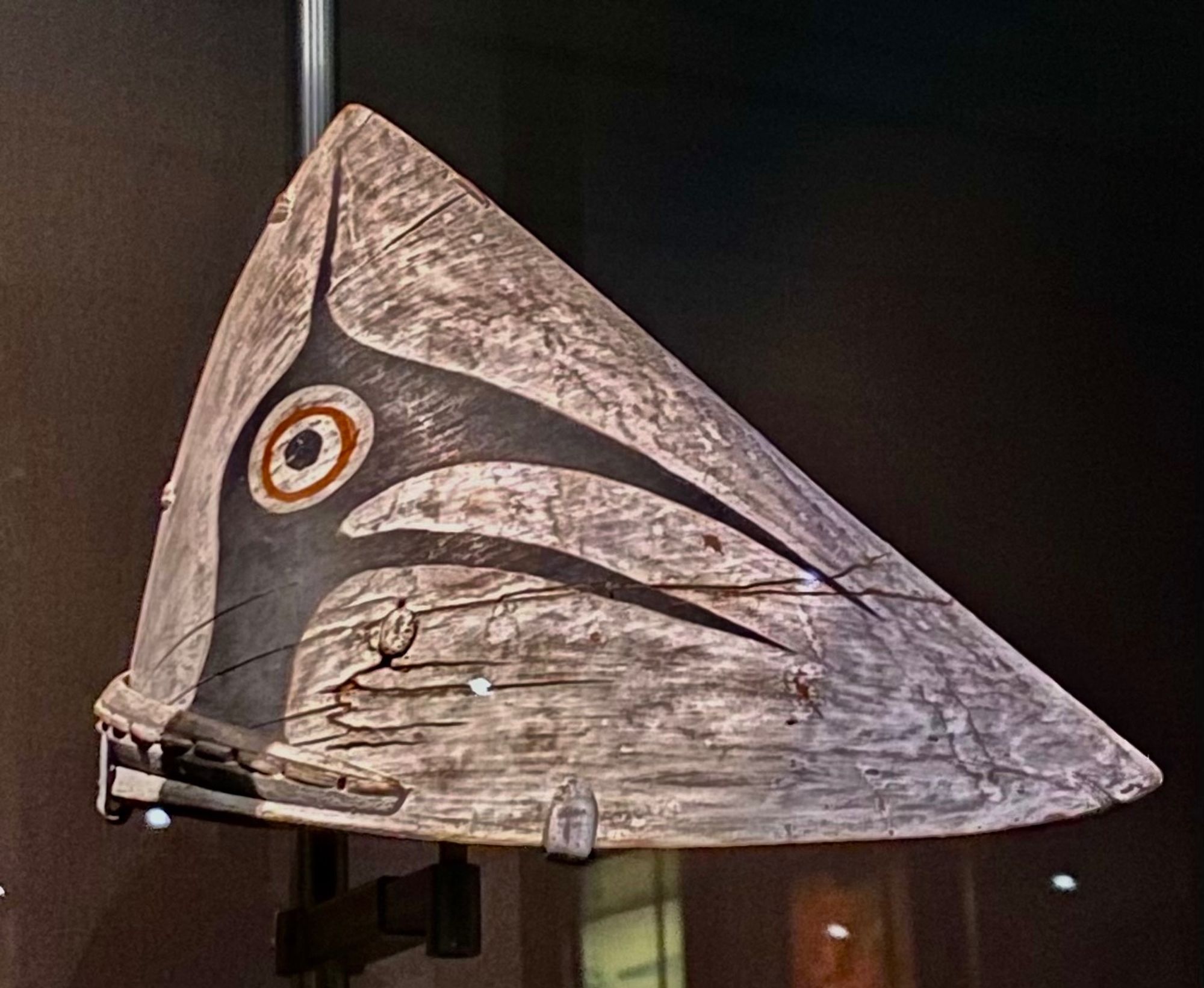 A conical Indigenous kayak hunting hat with a bird design on it