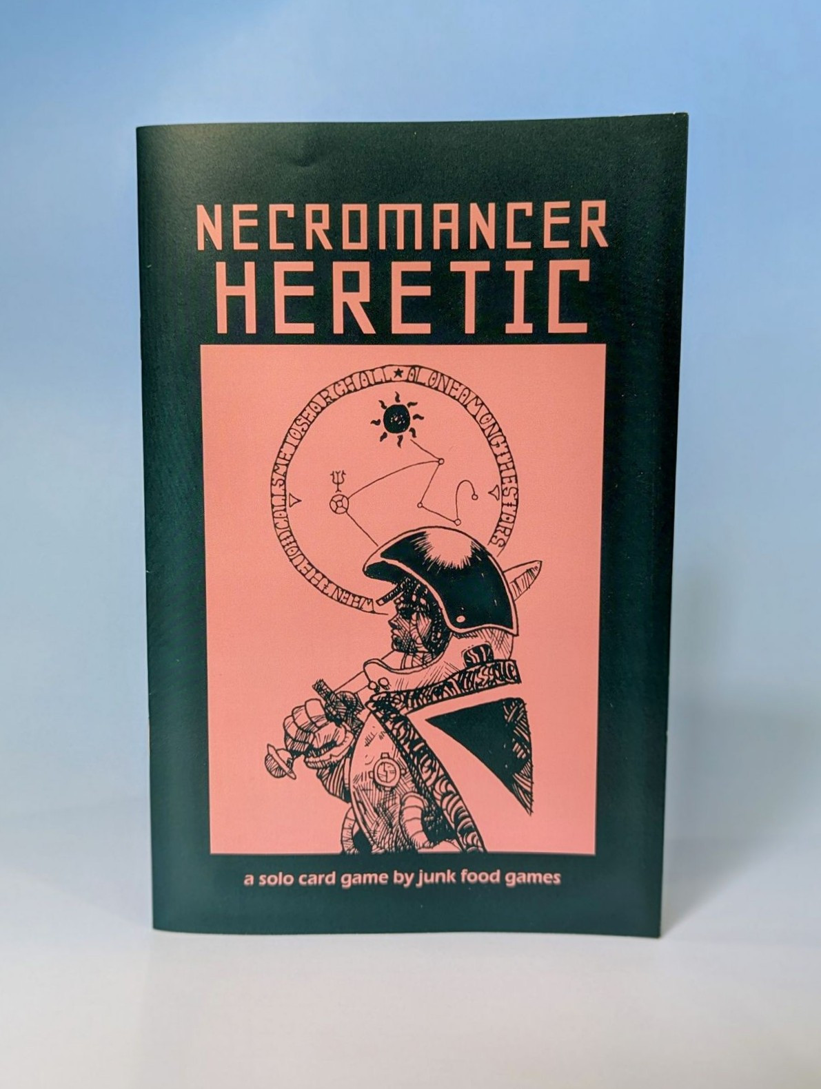 A guard in a bubble-helm stands in front of an arcane symbol on the cover of Necromancer Heretic.