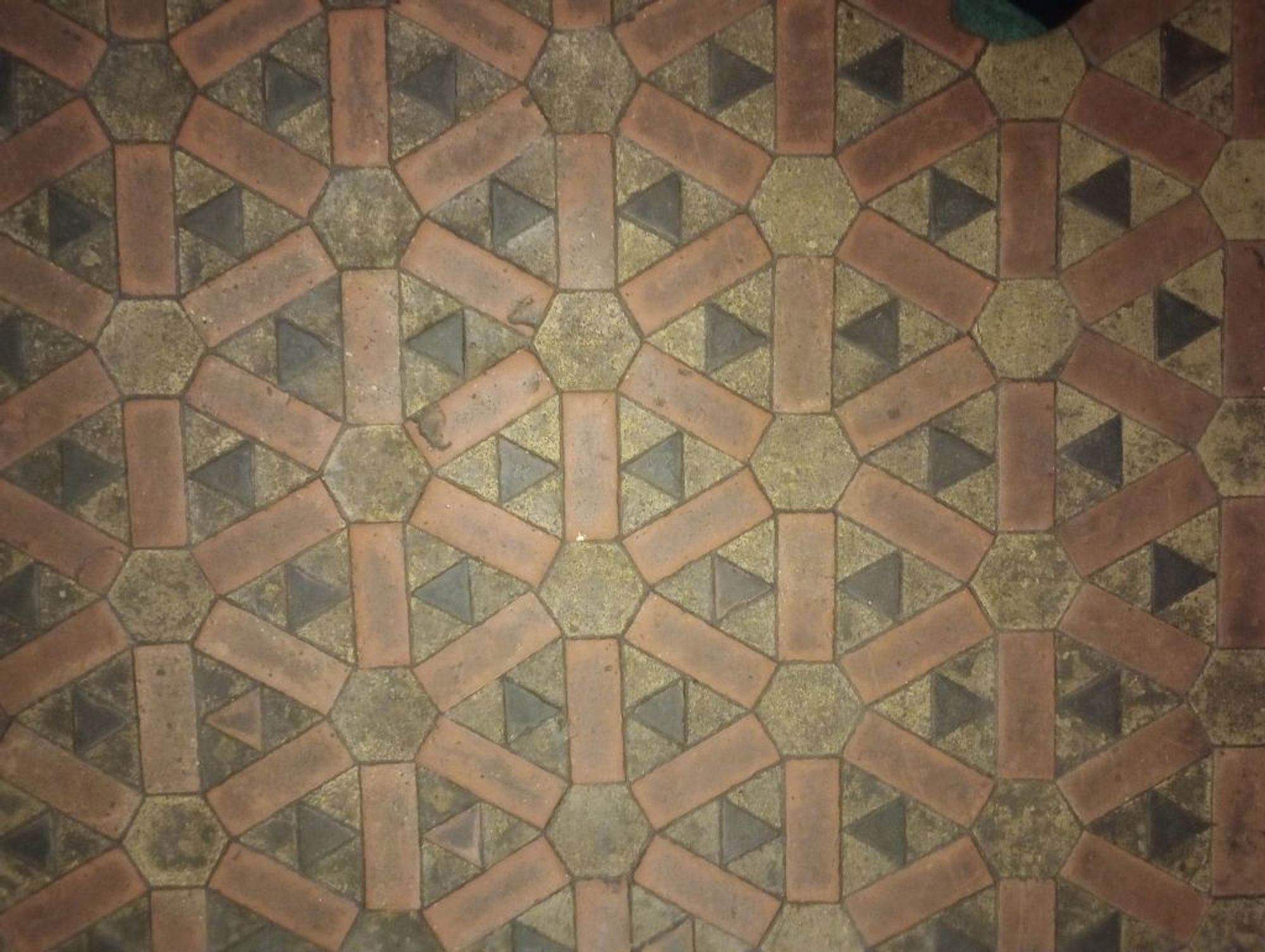 Orange, yellow and black tiles forming hexagonal pattern.