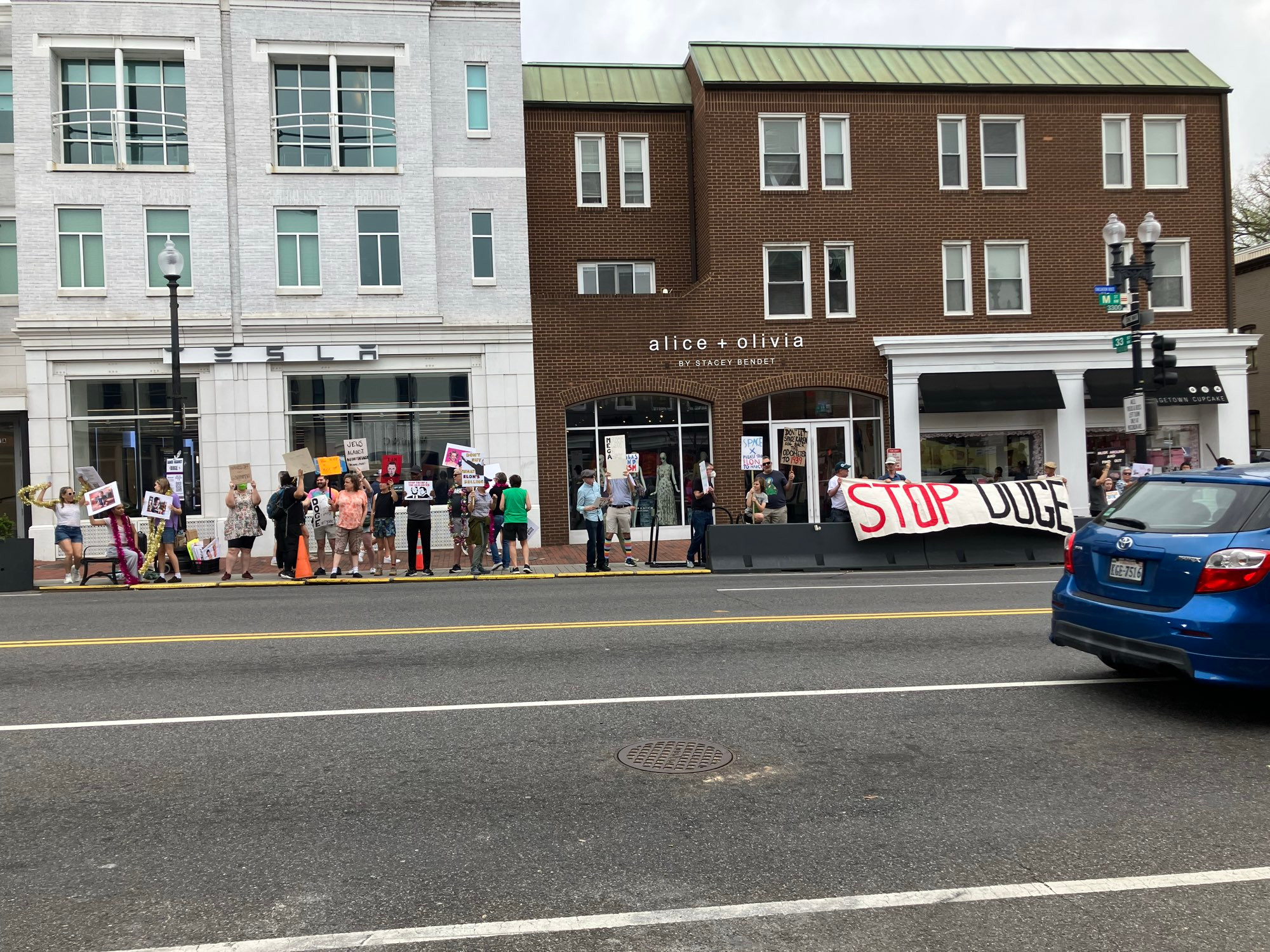 People standing on M Street in front of the Tesla showroom yelling at Elon Musk. Cuz he’s an asshole.