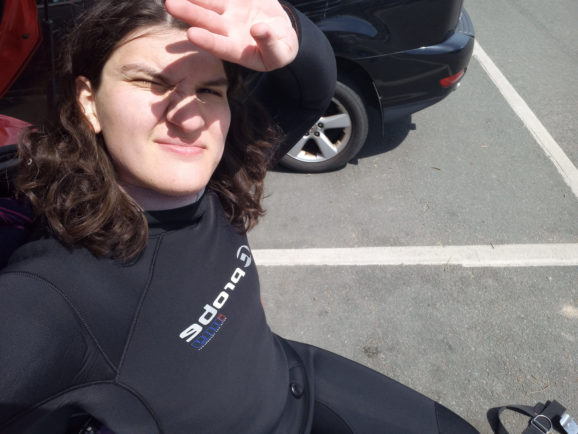 Me sitting on the back of my car in a carpark after a couple hours on a dive boat.
I am squinting into the sun