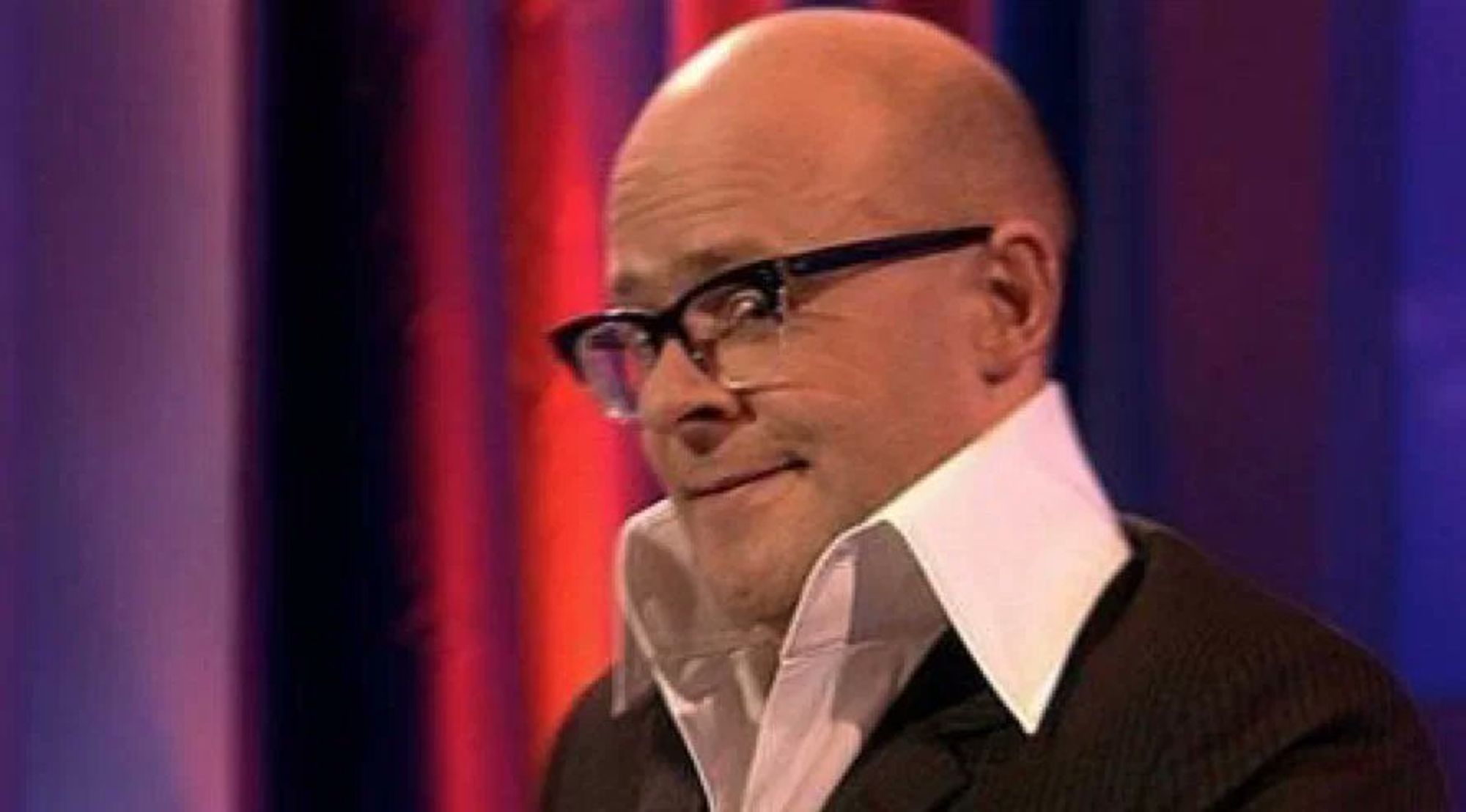 Harry Hill, looking sideways to the camera.