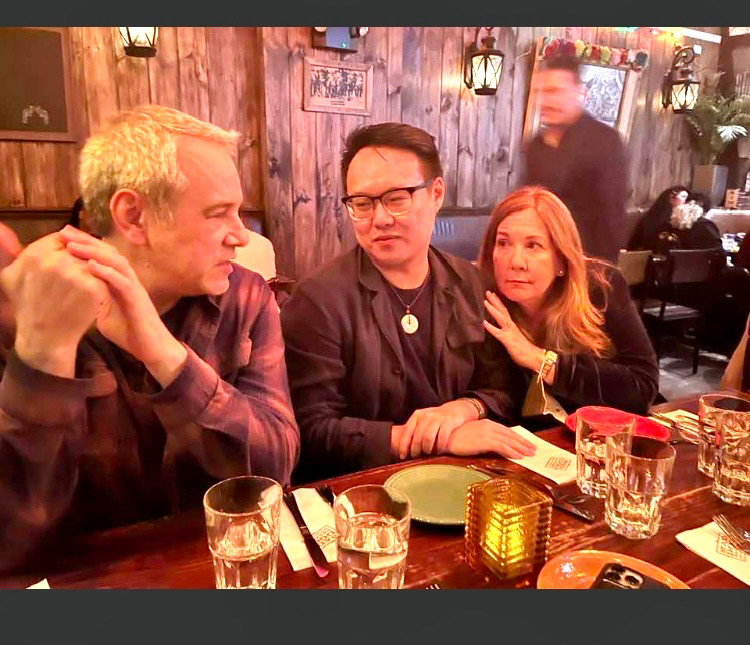 Mark Bibbins, Jay Gao and Erin Belieu at a table drinking margaritas