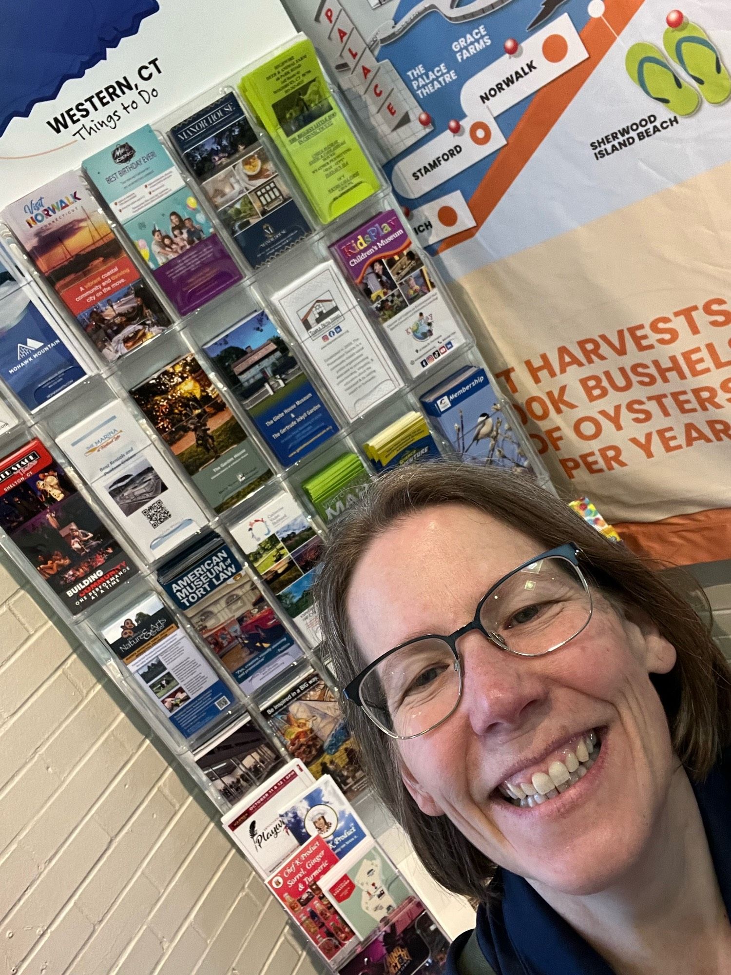 A smiling person at an info desk