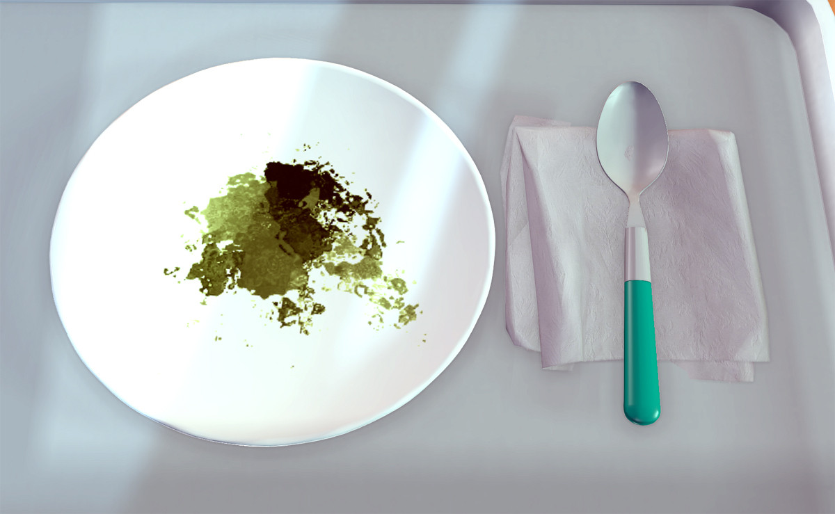 A plate on a tray with a spoon and napkin next to it.
Green goop/paint is smeared on the plate.