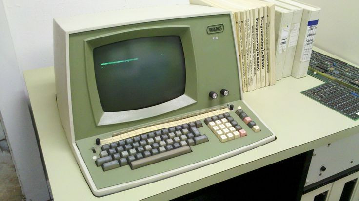 A Wang 2200 PCS II minicomputer circa 1977 on a desk next to several (presumably) programming/computing books.