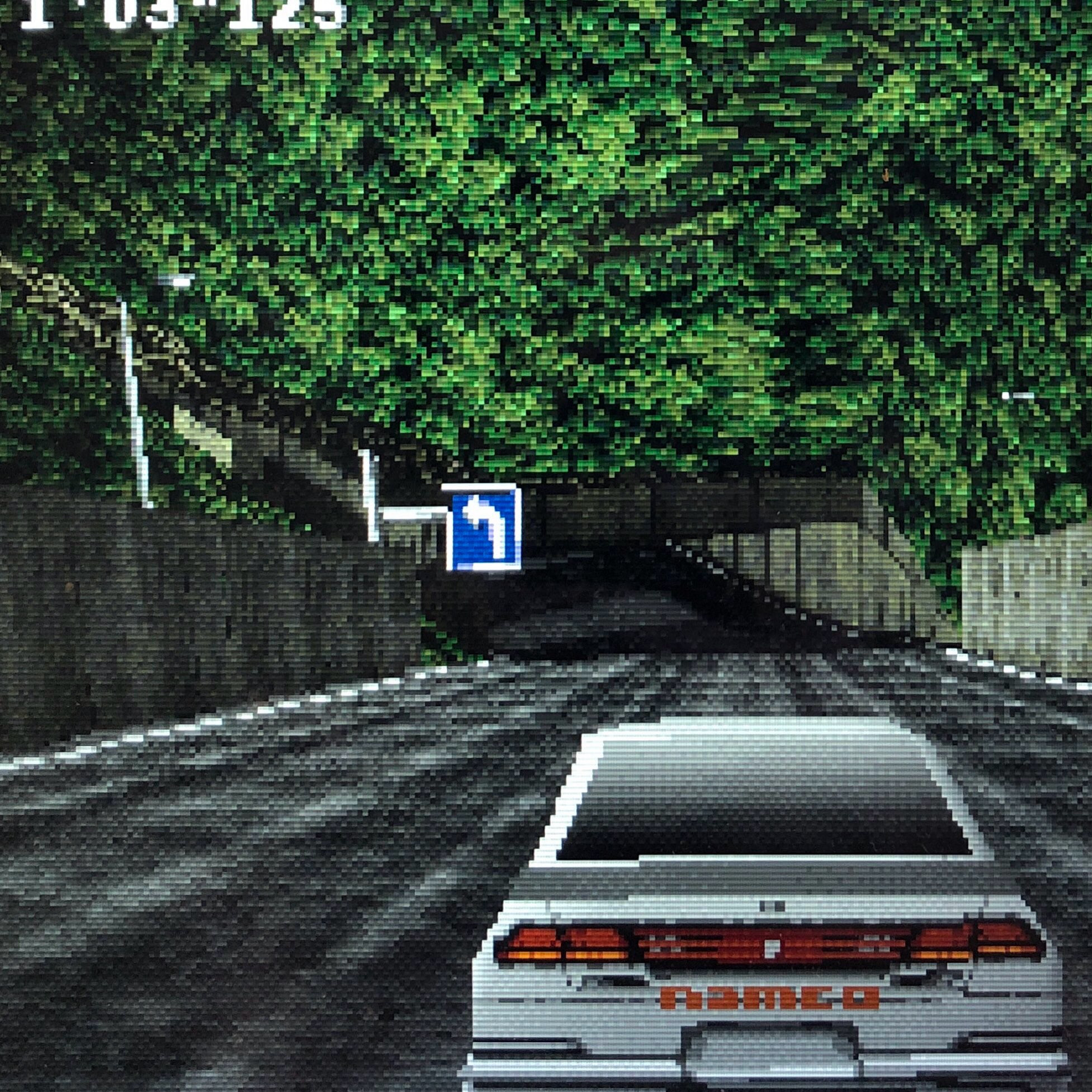 white car approaching a tunnel hidden amongst the trees