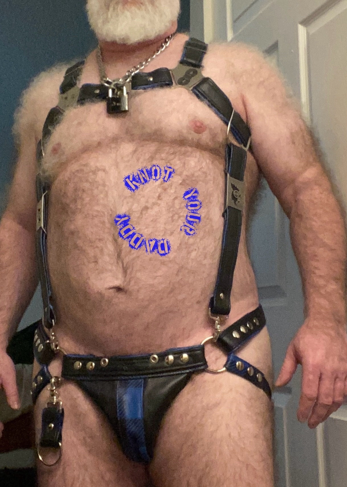 Daddy is wearing a full harness, seen from the front.