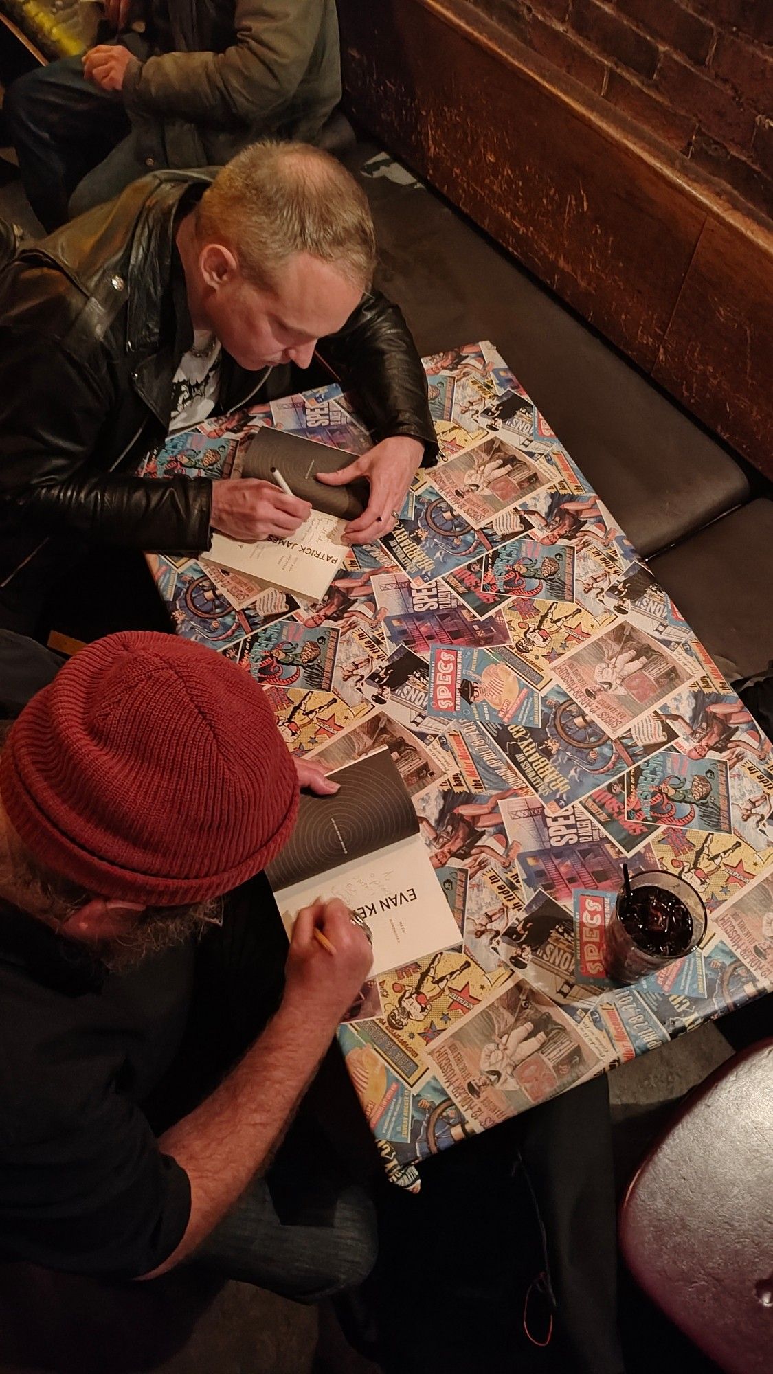 Evan Kennedy signing City Bird and Other Poems by Patrick Dunagan, and Patrick Dunagan signing Metamorphosis by Evan Kennedy