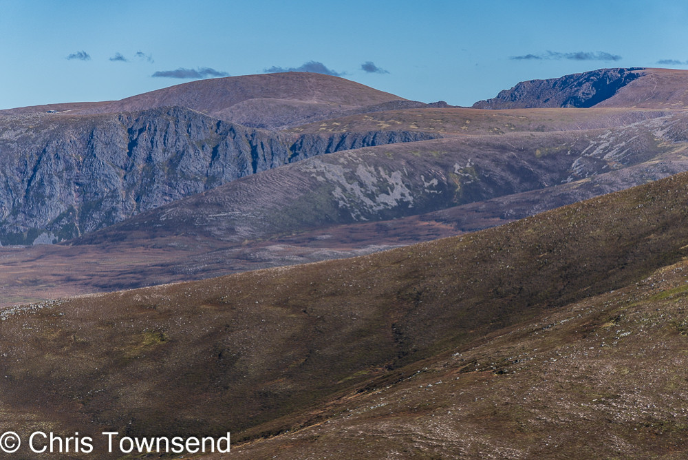 Brown mountains with cliffs under a blue sky