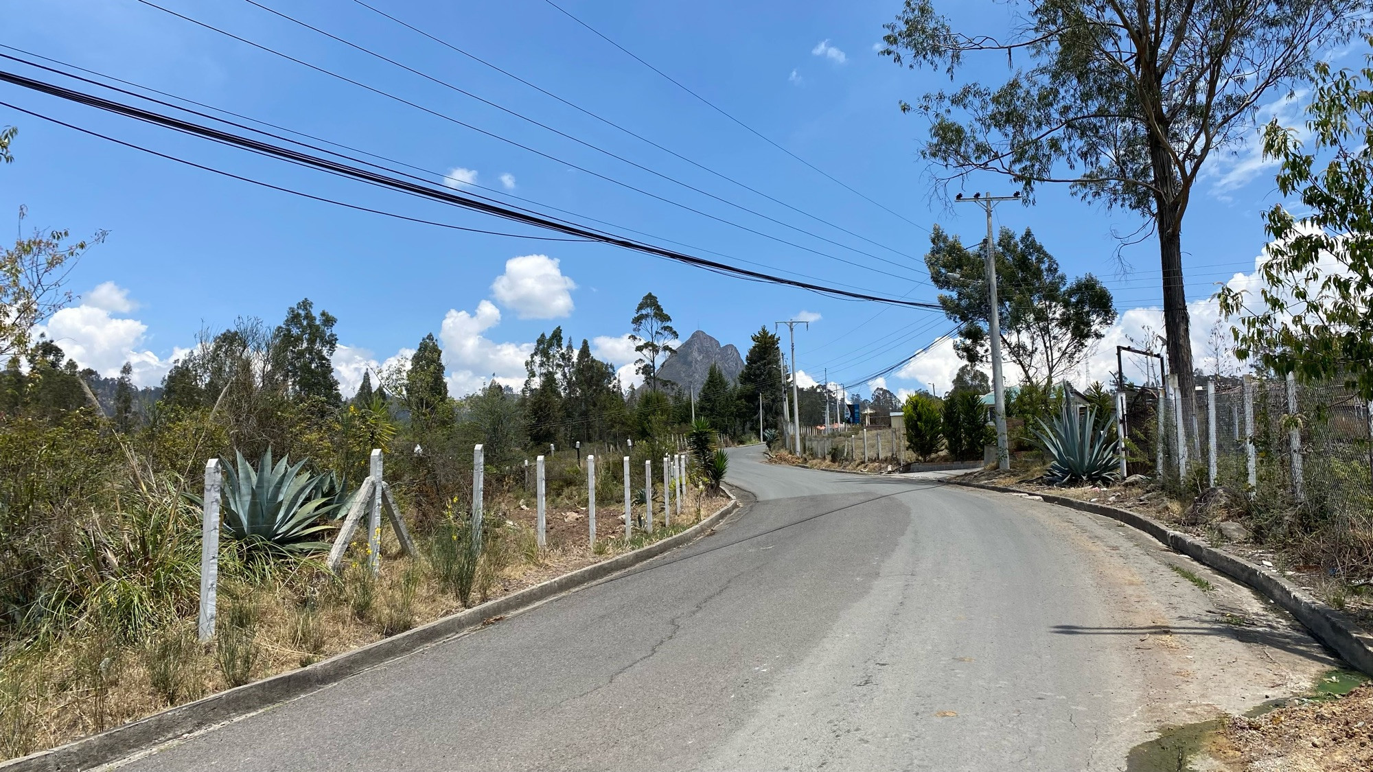 the hardest climb in cuenca that i know of. a road stretches towards a huge rocky outcrop 