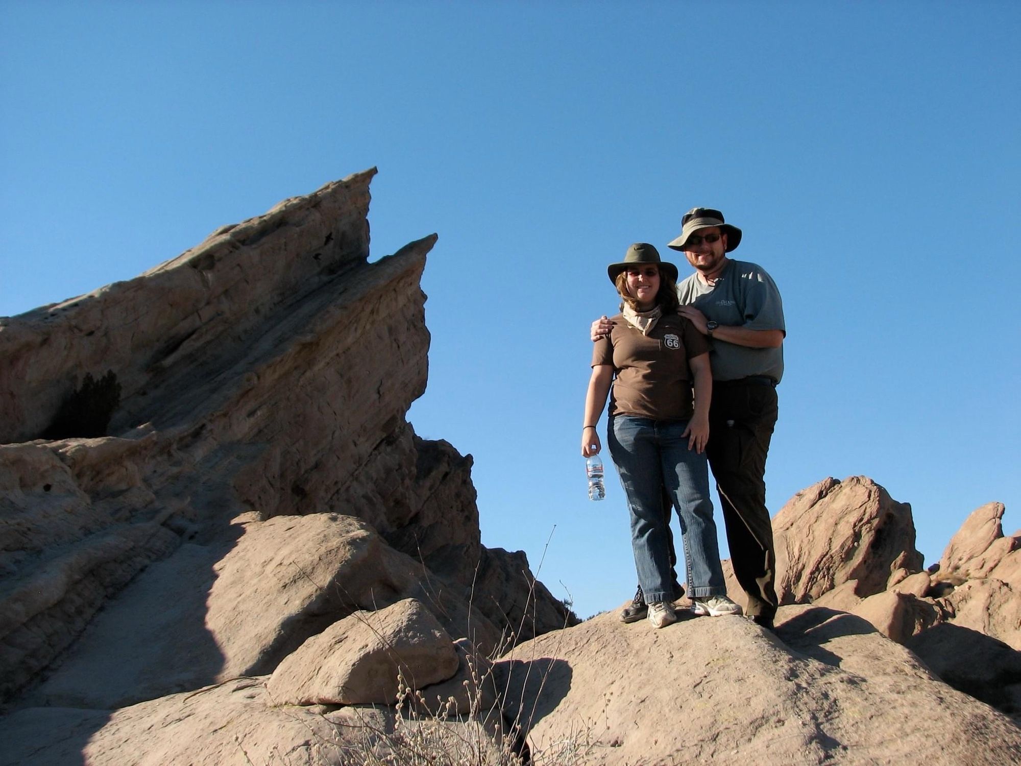 Me and my husband standing on top of a boulder next to Vasquez Rocks, the Star Trek rocks