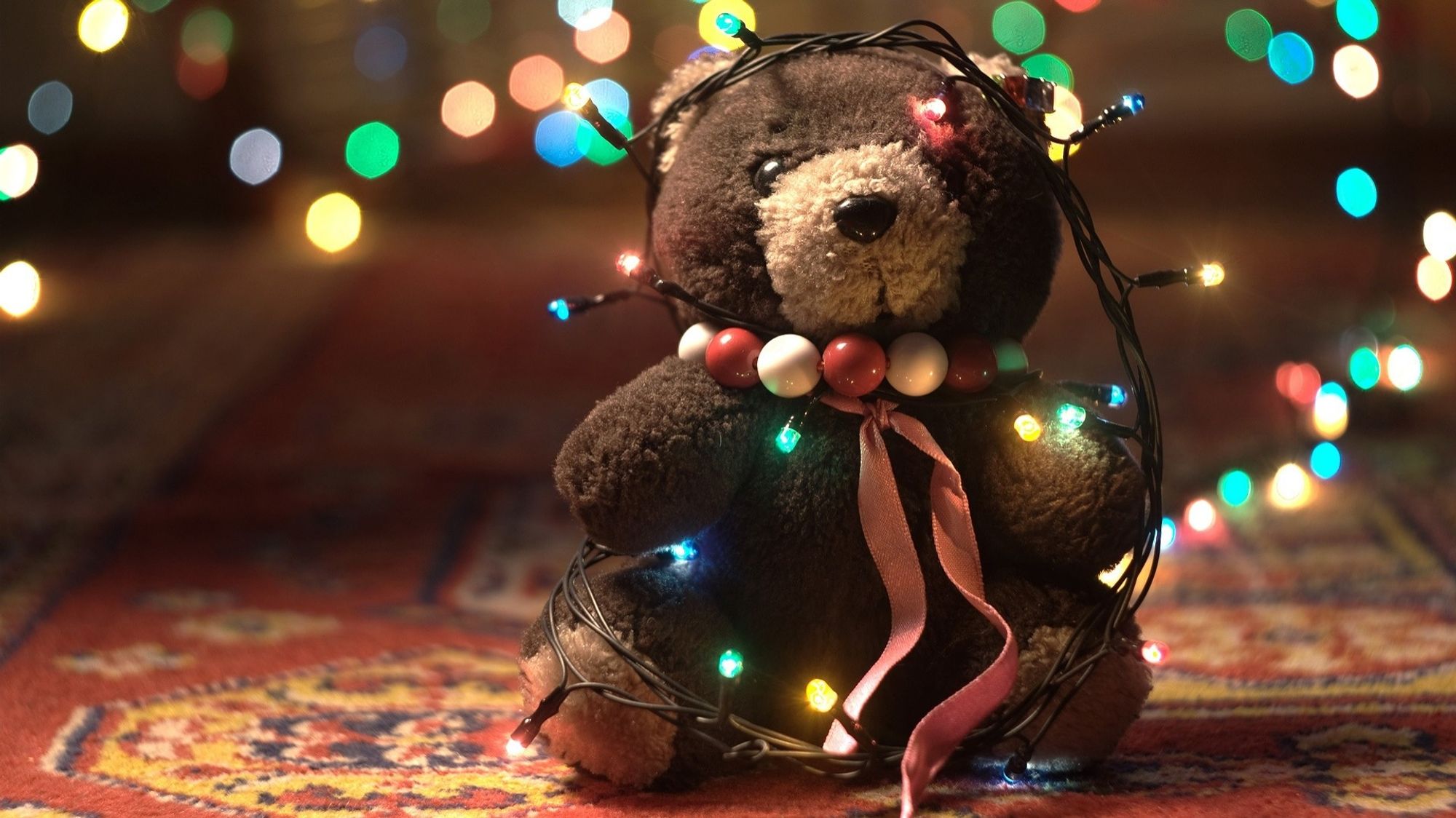 Pic of teddy bear with Christmas garland.