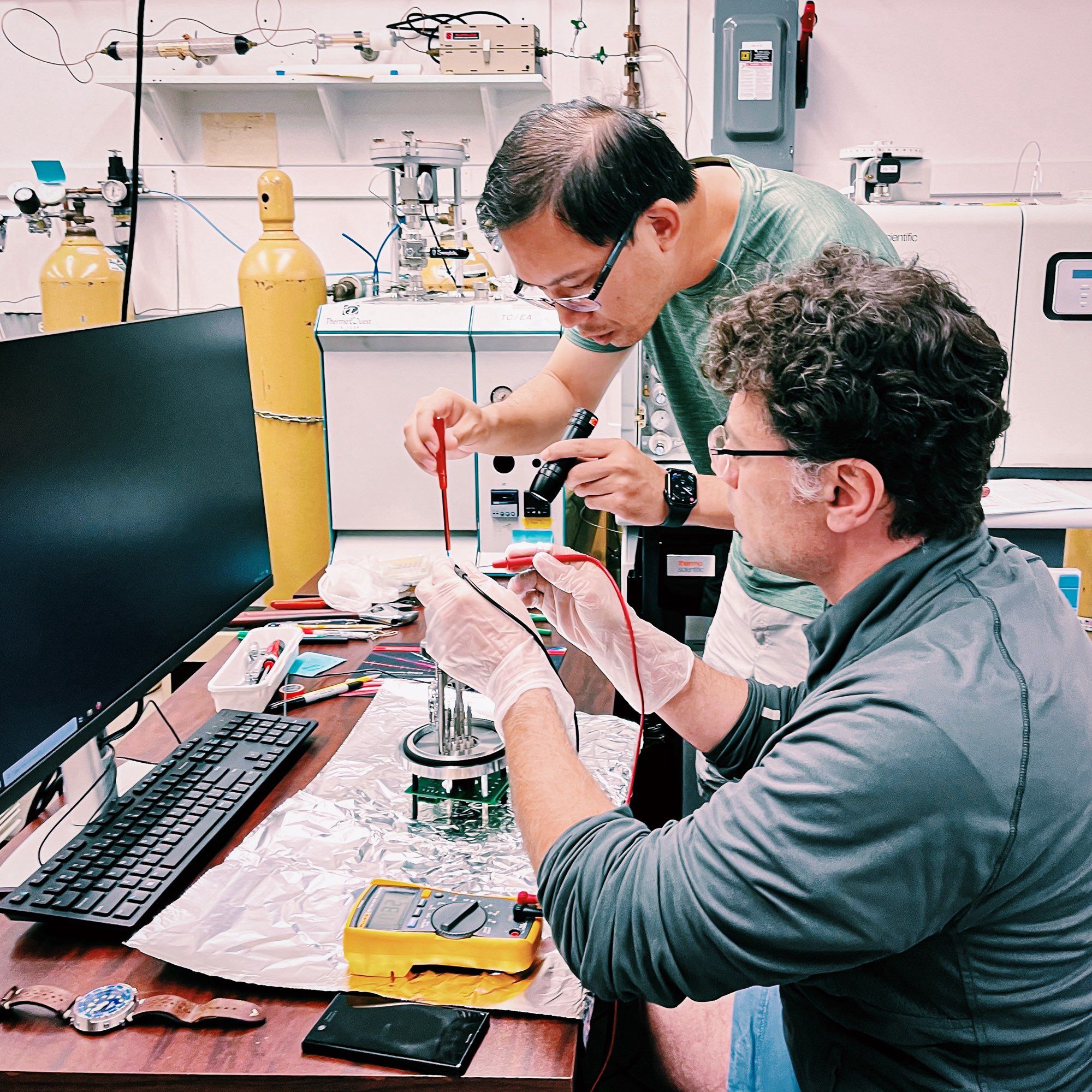 Two scientists working on an instrument