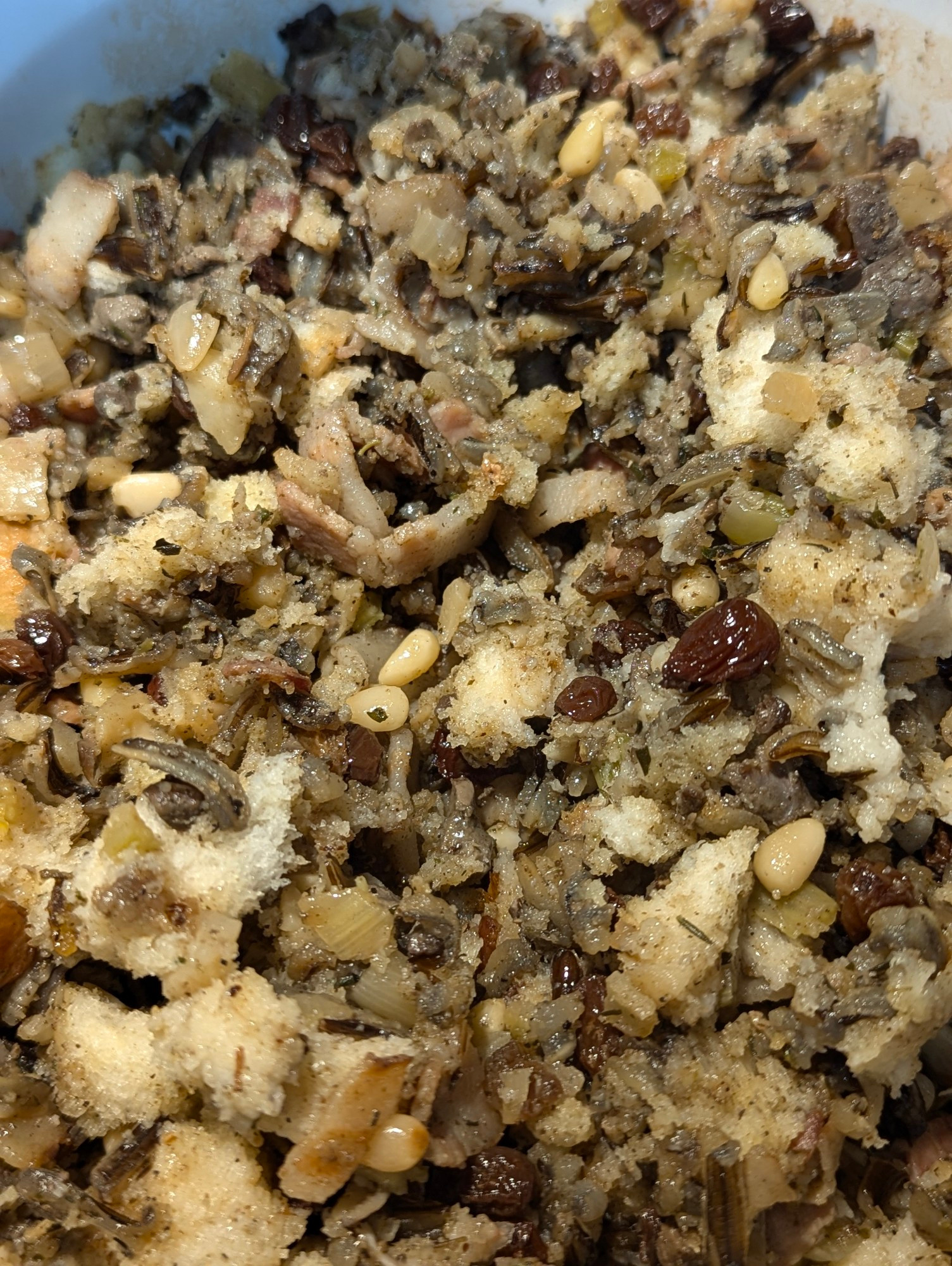 Bread stuffing with pine nuts, wild rice, raisins, apple, water chestnuts , onion and celery. And bacon 