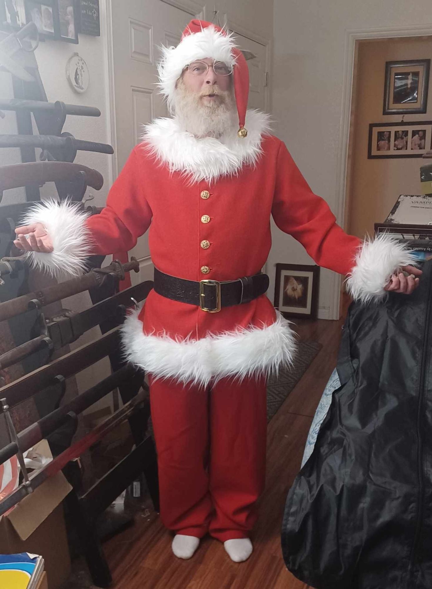 A re-creation of an 1950s Coca-Cola Santa Suit. Red wool with white trim, a black leather belt and gold buttons. The hat has a brass bell on the tip of it.