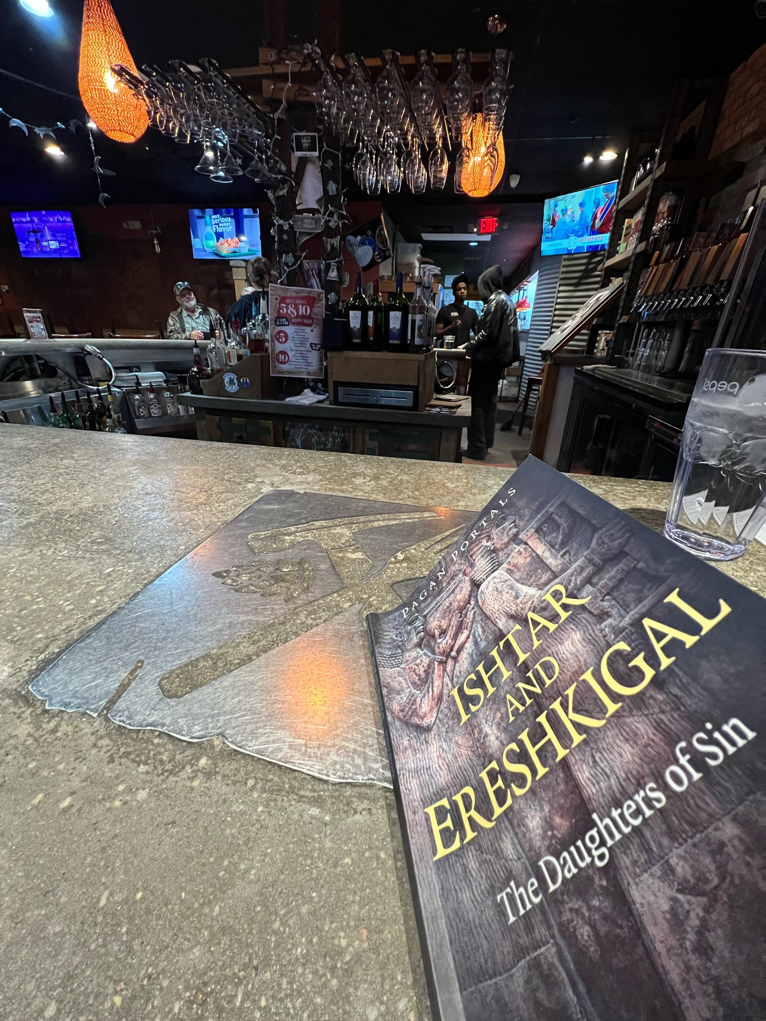 Photo from Brickworks Brewpub in Smyrna  DE  - it’s a granite bartop & the cover of a book I could barely read, 
ISHTAR AND
ERESHKIGAL
The Daughters of Sin by Scott Irvine