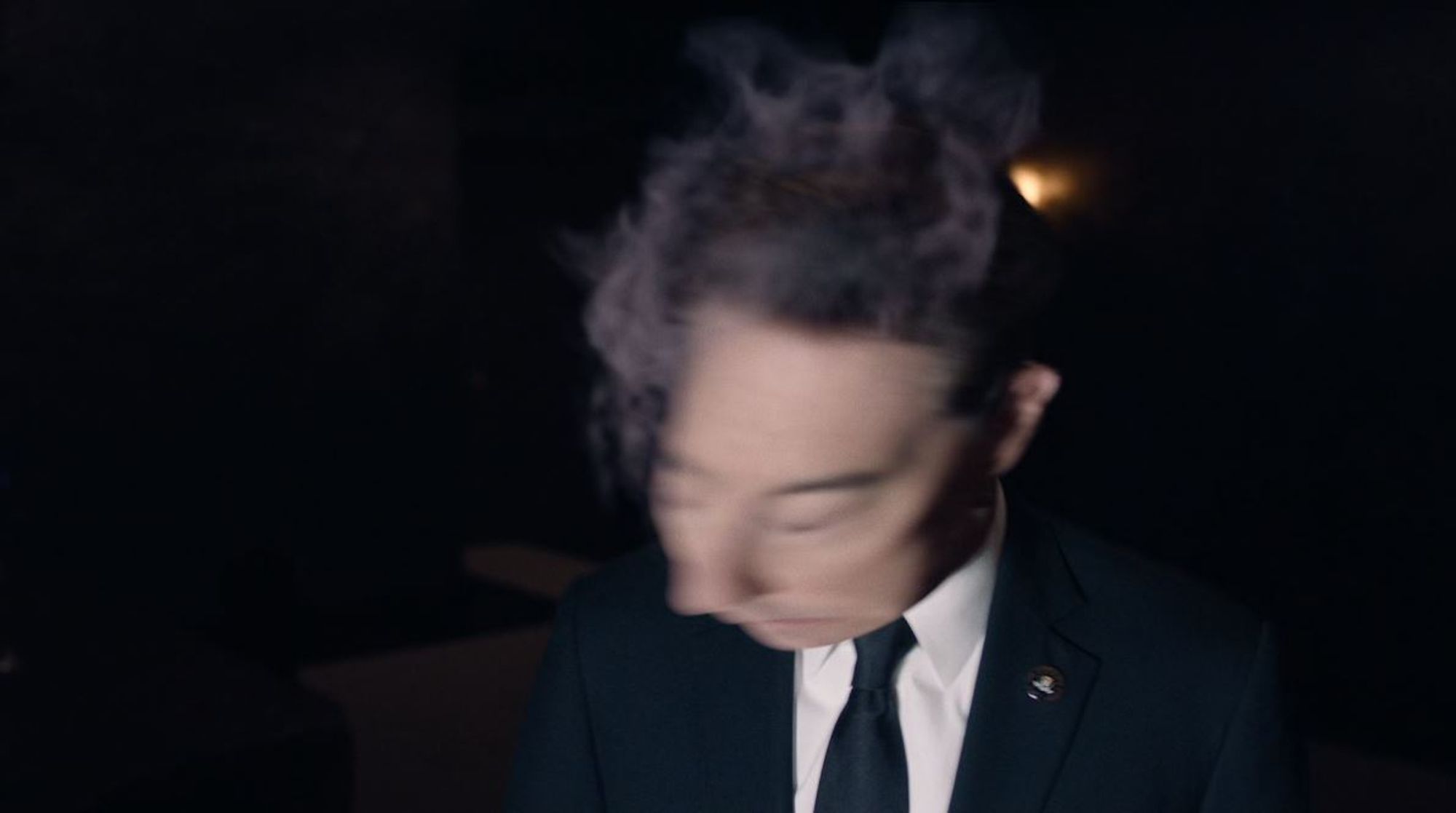 Dale Cooper from a scene in season three of Twin Peaks, in which his head and face are distorted and smoking because a large electrical socket has tried to suck him into a dimensional transporter