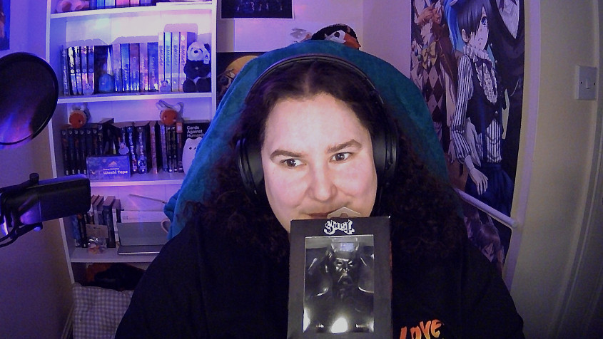 Cosmic holding a boxed Nameless Ghoul mini bust from the band Ghost!