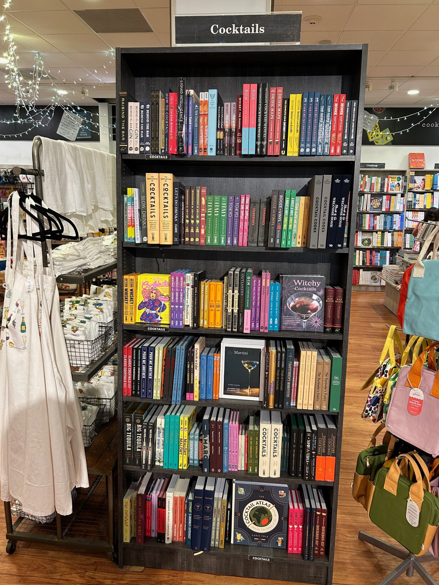 A six-shelf bookcase labeled "Cocktails."