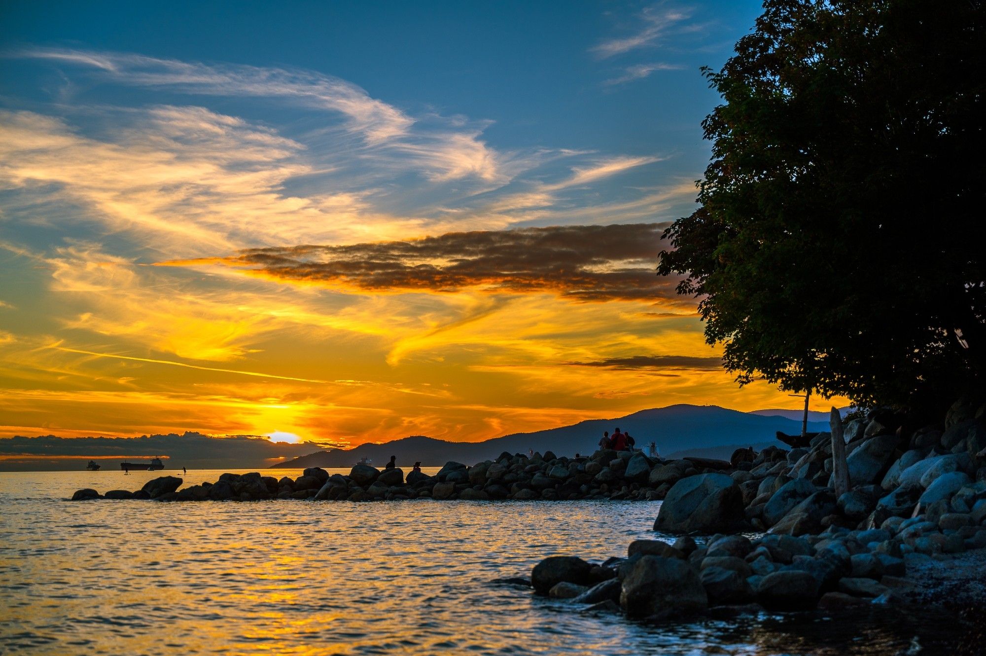 Orange and yellow sky at sunset golden hour over the rocky shoreline of English Bay, Vancouver, British Columbia, Canada
Captured by Komeil Karimi