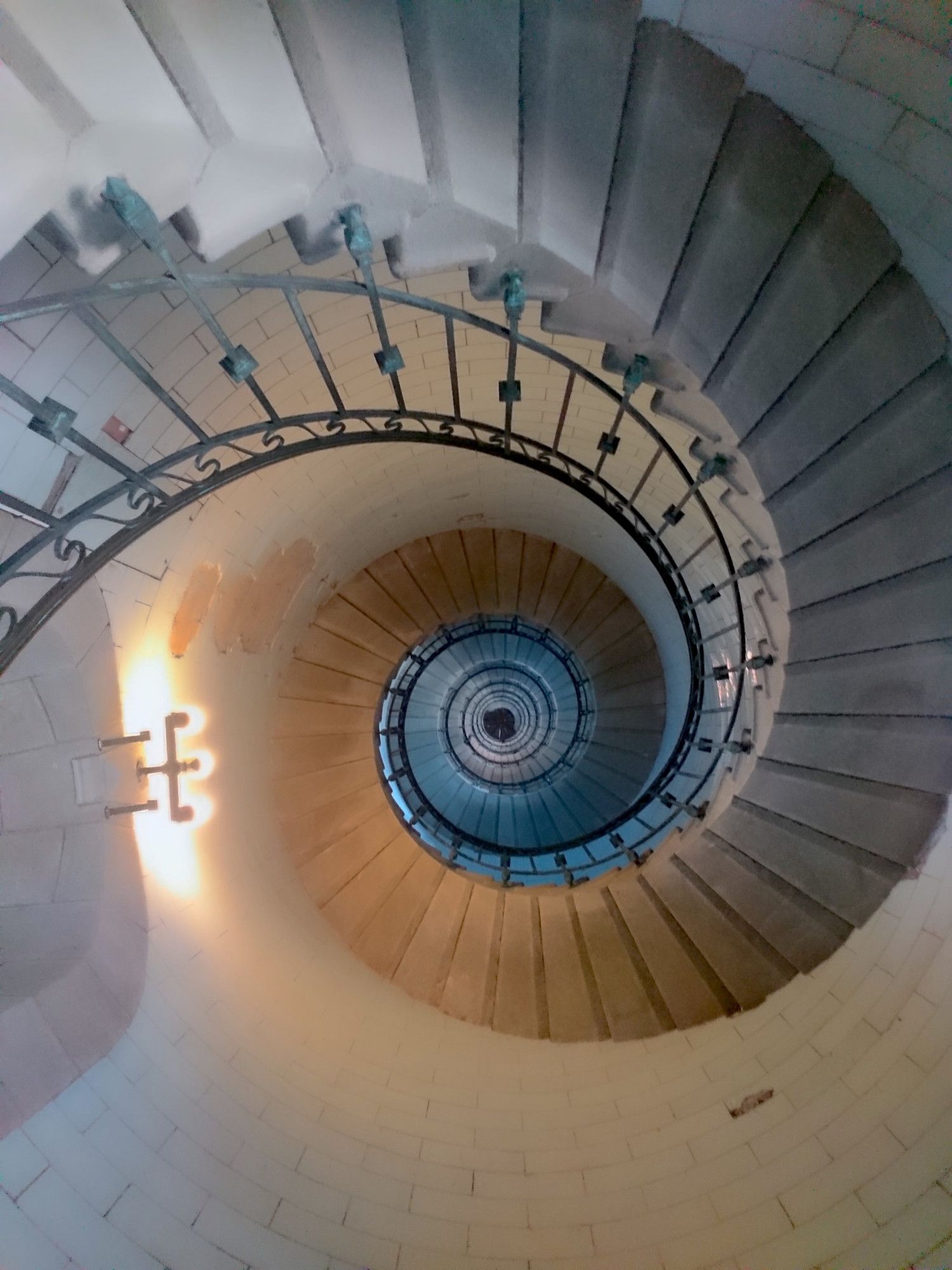 Vue des marches de l'escalier en spirale du phare d'Eckmühl vu du bas