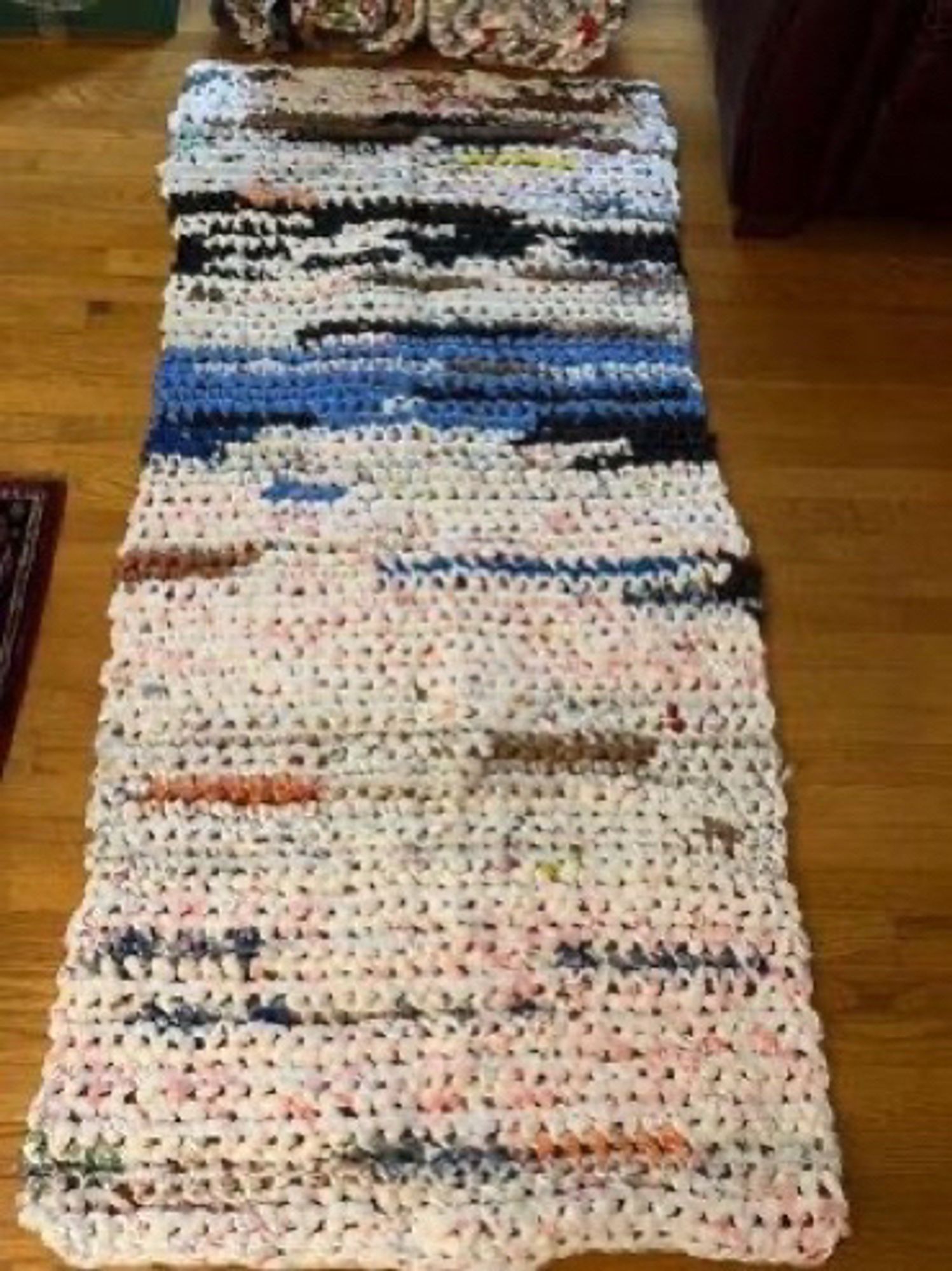 One of the sleeping mats rolled out, it’s about the length of an adult sleeping bag and has different colors woven throughout it from the recycled plastic bags