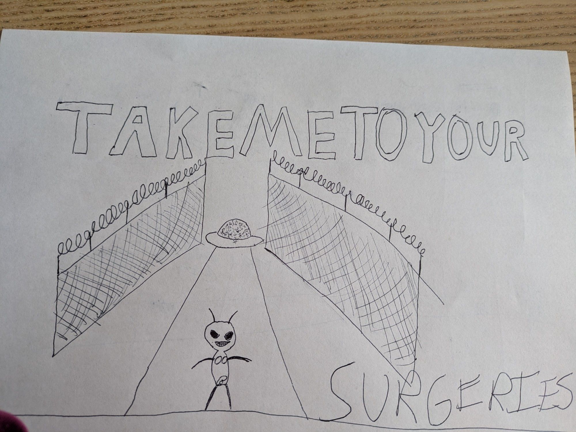 An illegal alien beamed down from a UFO saucer into a barbed wire enclosed jail demands "Take me to your surgeries!"