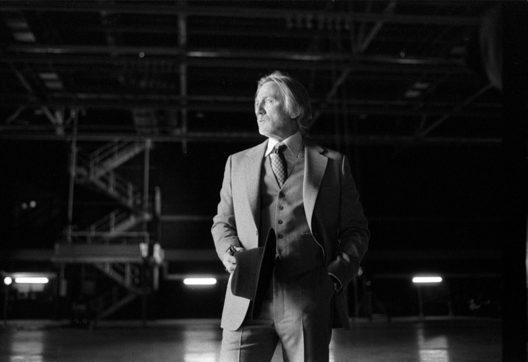 Daniel Craig as Benoit Blanc in "Wake Up Dead Man: A Knives Out Mystery", the third entry in Rian Johnson's Cajun detective franchise. He wears a suit with longer hair and a beard, differentiating his look from the previous two movies. The photo itself is in Black and White.