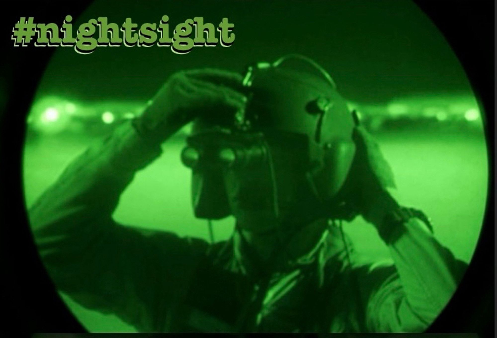 What looks like a soldier with a helmet on, viewed through a night sight