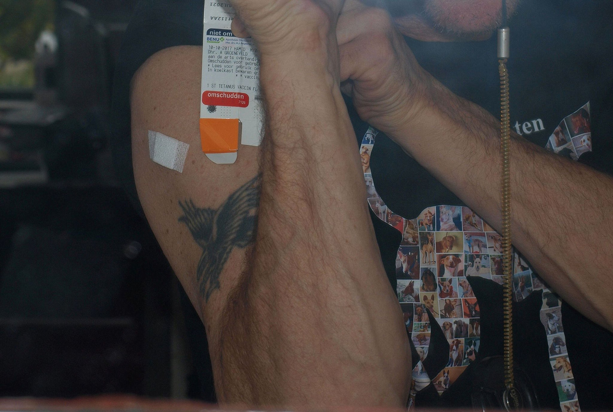 Selfie taken in a mirror showing just my arm with a single tattoo and a small band-aid where I got a tetanus booster shot. Also visibly holding the vaccine packaging with a date on it, so I'll know when it's time for the next one.