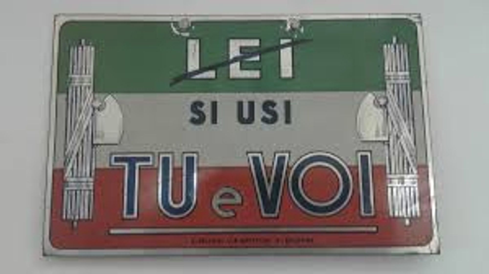 historical signage with the Italian flag, it says: ley (crossed out), si usi tu e voi