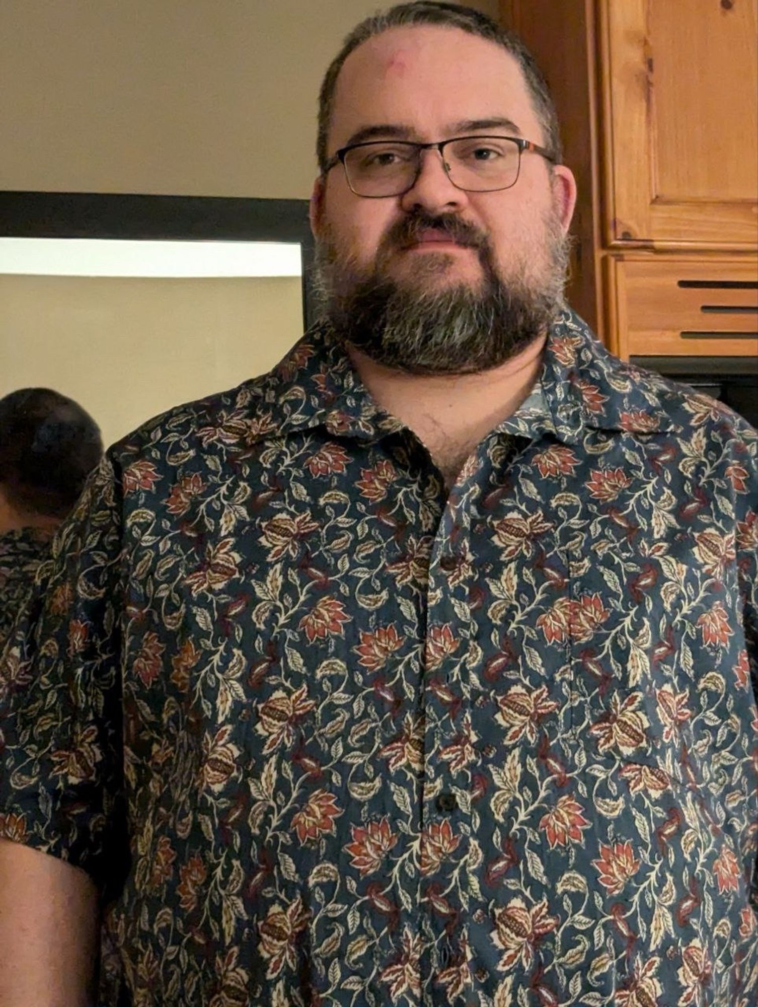 Me (Kane) wearing a collared shirt my Mom bought for me at JcPenny’s today. Clear view of my emerging bald spot in the mirror behind me.