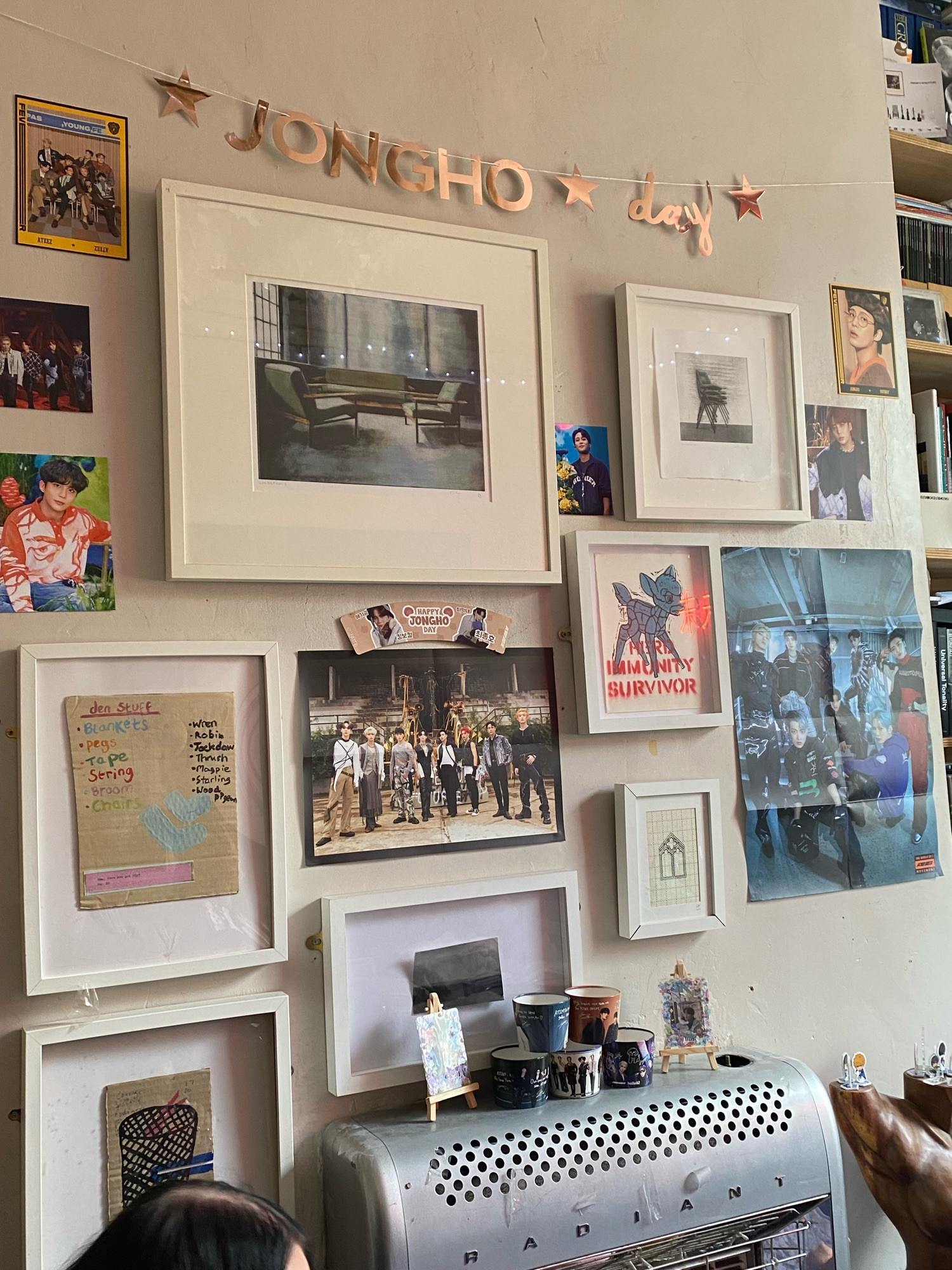 Jongho Day on the wall with various Ateez posters 