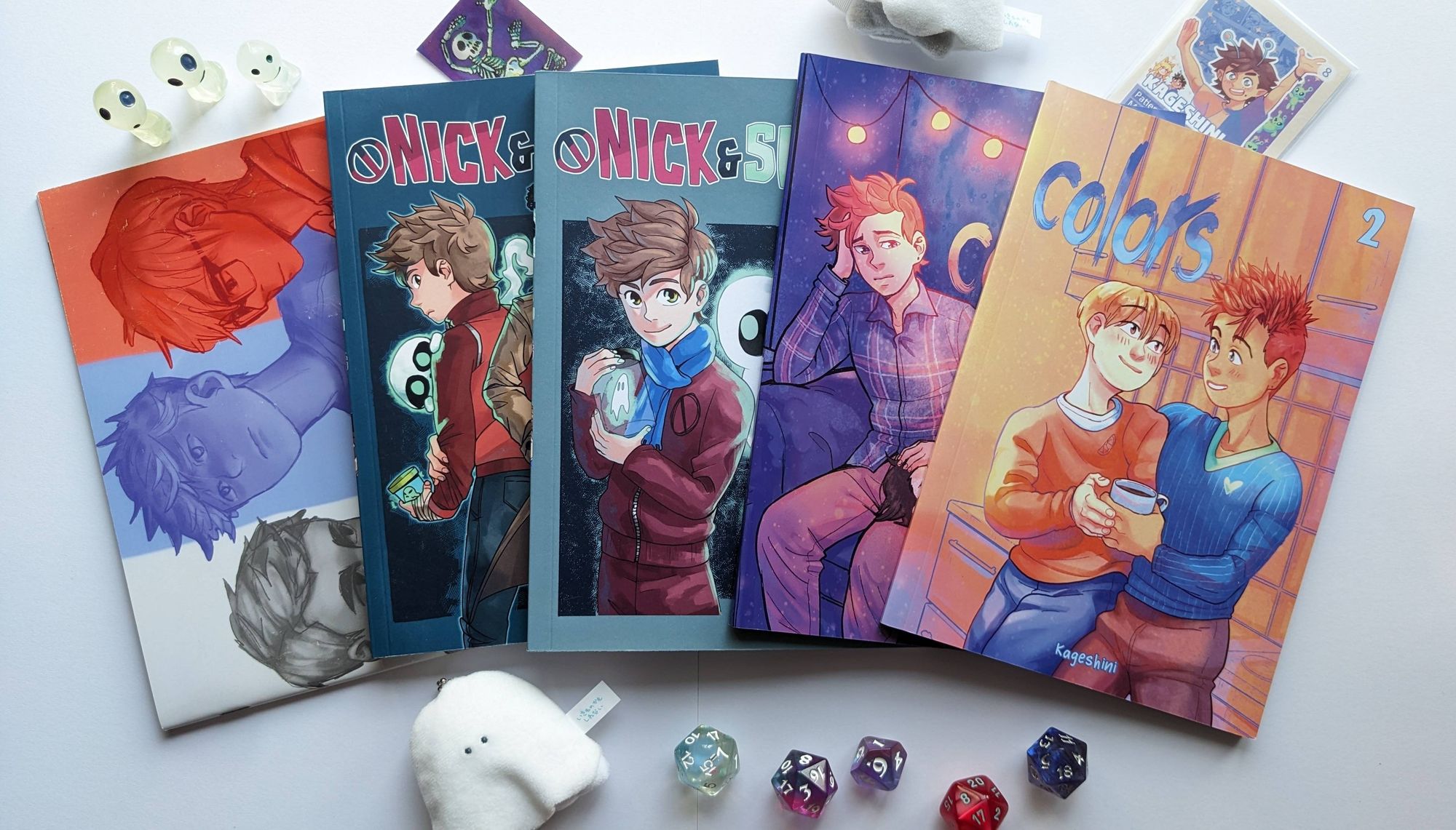 Product photos of my four comic books and fanzine, decorated with cute stuff