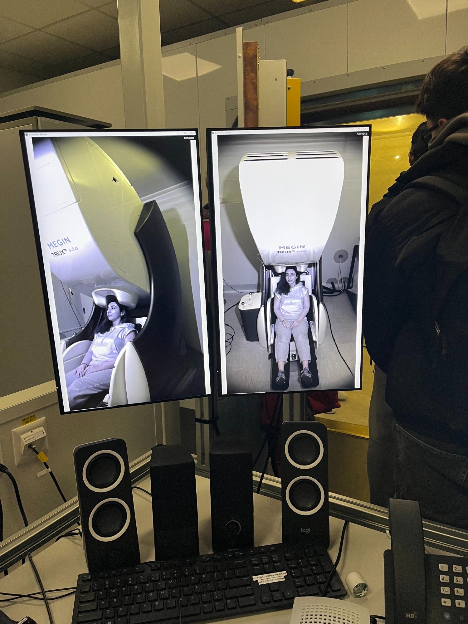 A woman sits in a MEG scanner