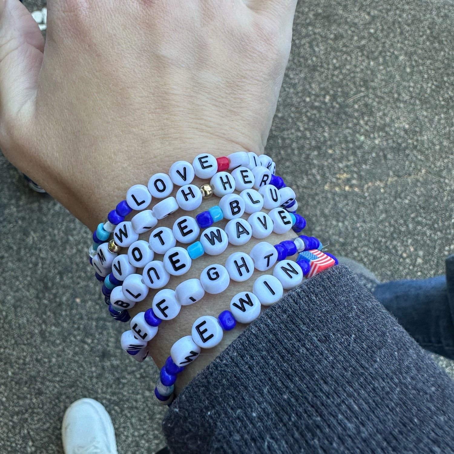 A bunch of Democrat themed friendship bracelets. They say: I’m with her, vote blue, blue wave, when we fight we win, etc. 