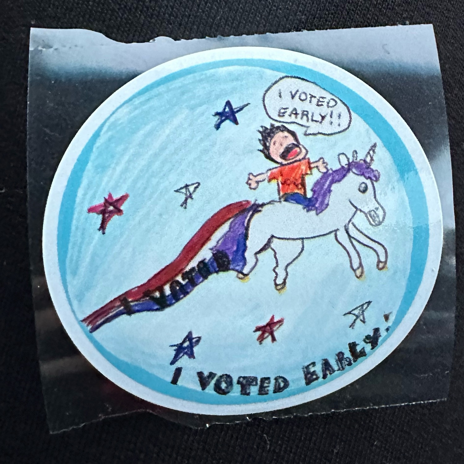 A sticker featuring a child’s drawing of a kid riding a unicorn yelling “I voted early!” Red, white, & blue stripes are flowing out of the unicorn’s butt. 