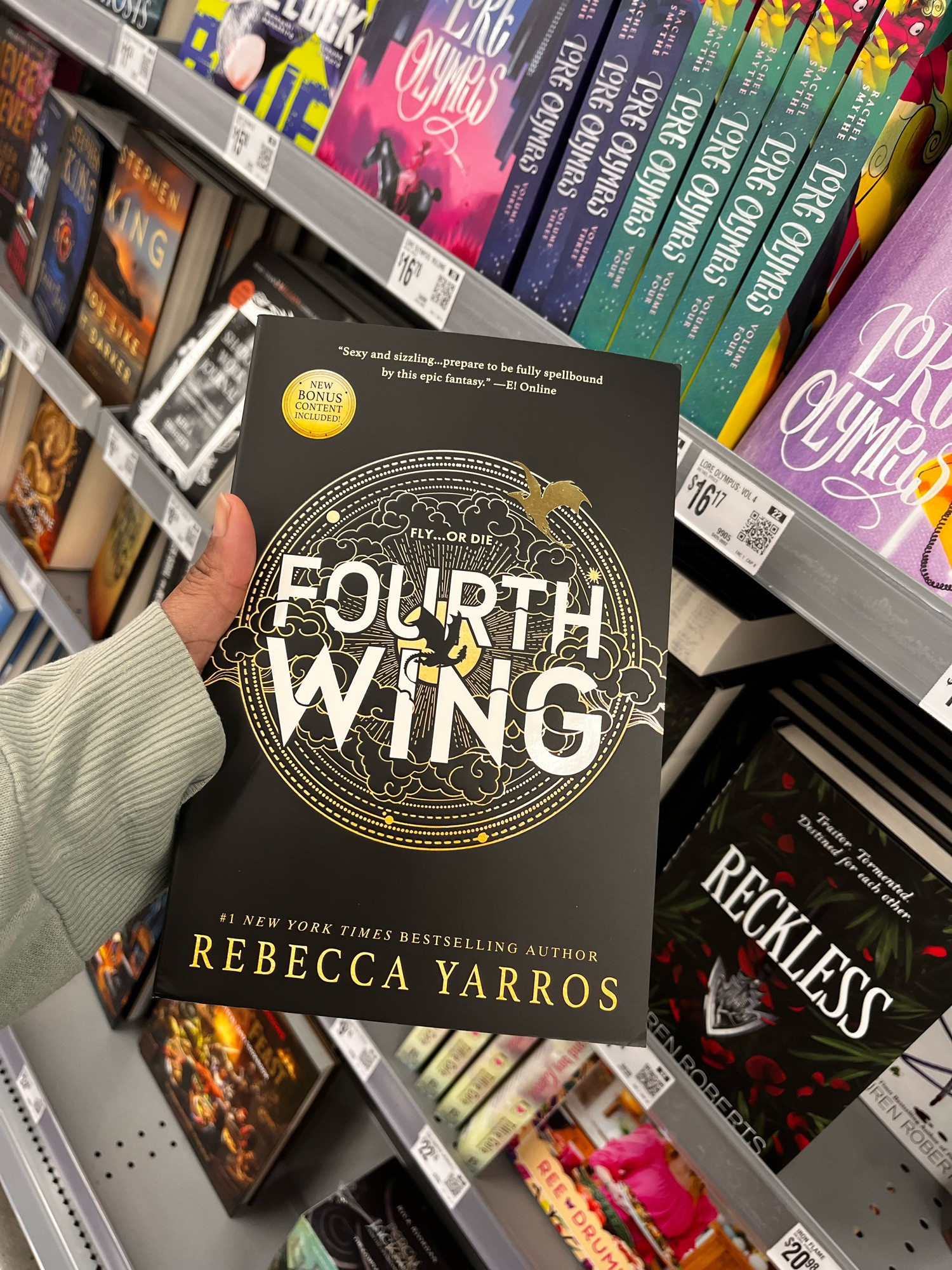 a picture of fourth wing’s cover and in the background is various other popular books! 