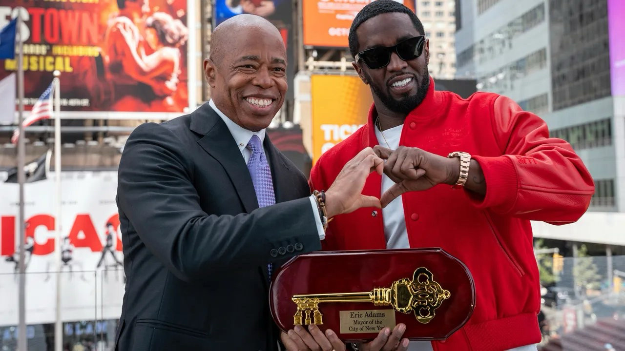 Eric Adams and Diddy making a literal hand heart together