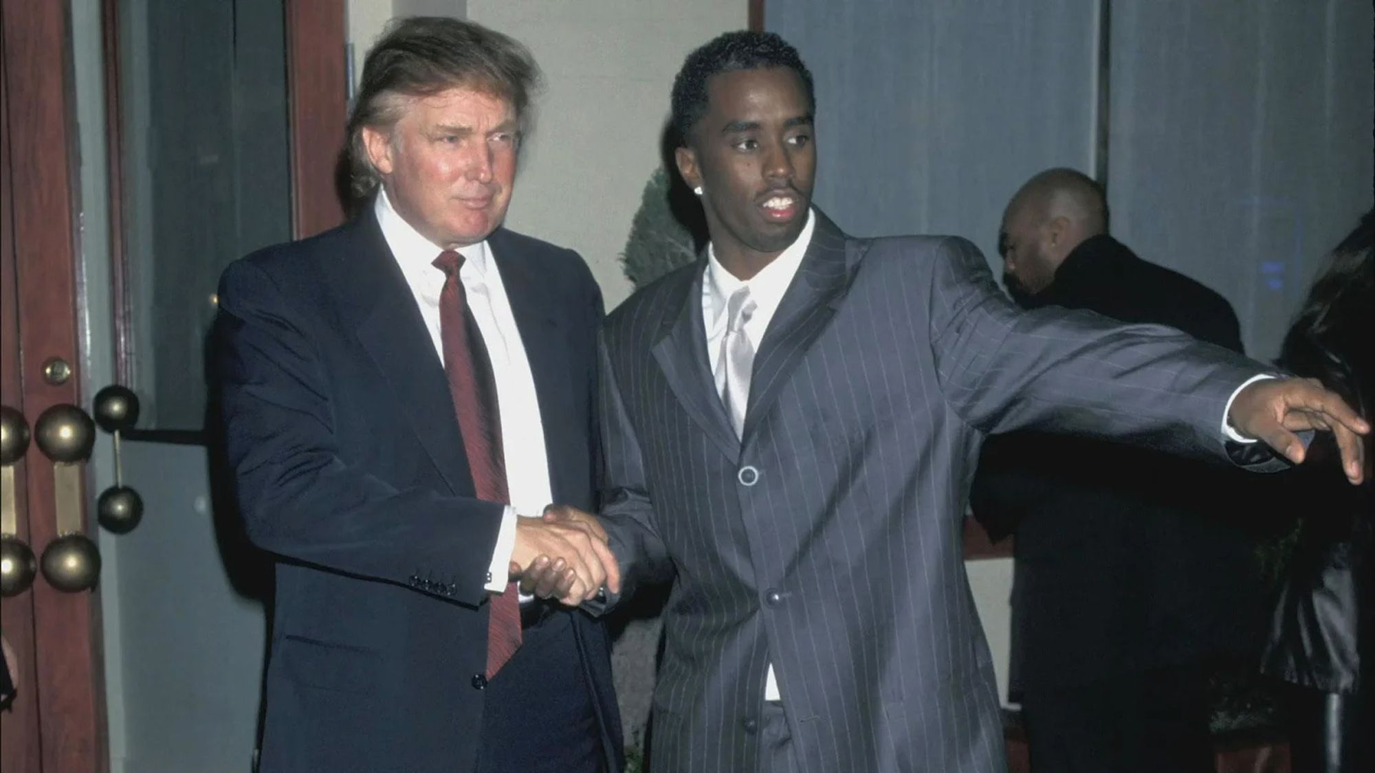 donald trump shaking hands with diddy, presumably in order to commit horrific crimes