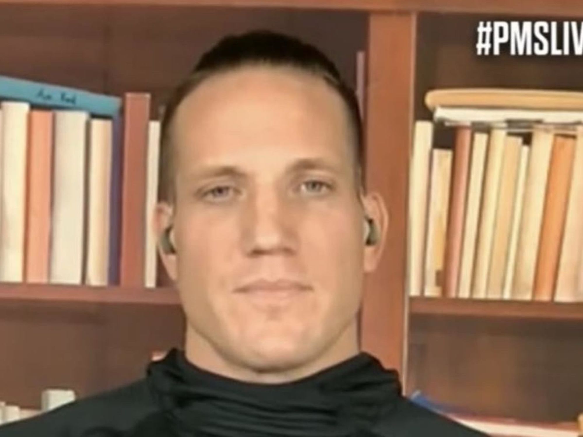 Pat McAfee barnacle AJ Hawk, who is paid more money than you will ever earn to sit in front of books he's never read (the spines are turned inward on the shelves behind him). He says nothing. He does nothing. He is the linchpin to this entire thing.