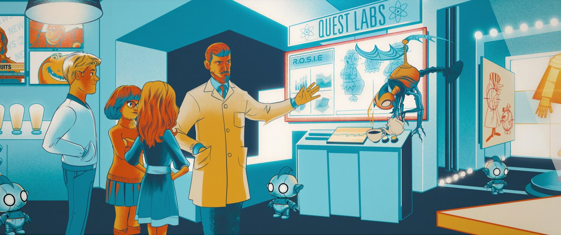 Fred, Velma, and Daphne stand next to Dr. Quest as gestures to a screen, above which is labeled Quest Labs.