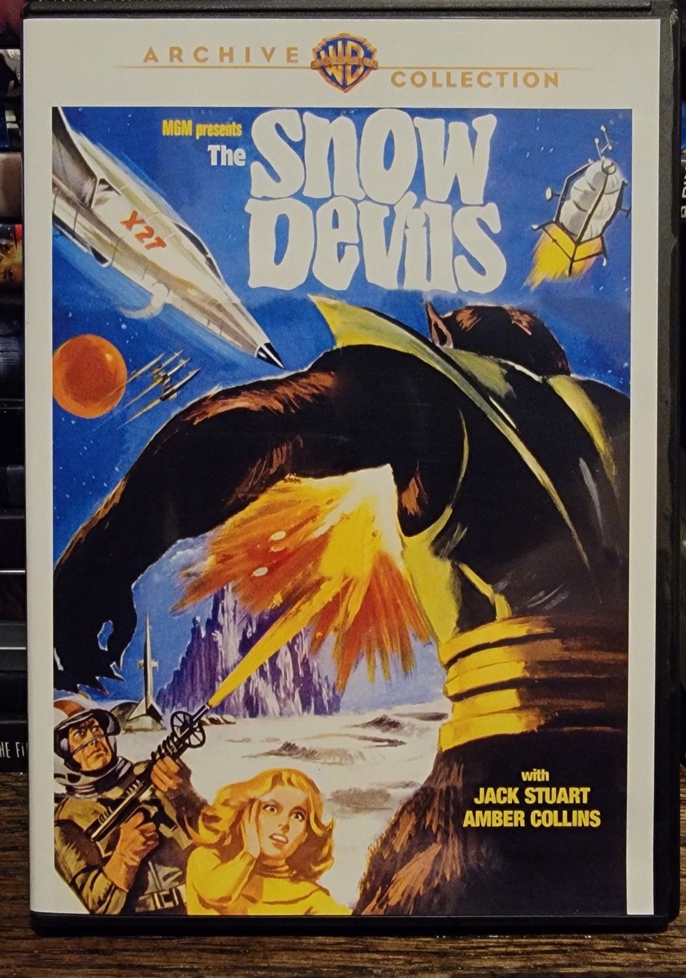 Dvd cover for the film Snow Devils. 
The image shows some human astronauts shooting a hulking alien. There are multiple spaceships visible in the sky.