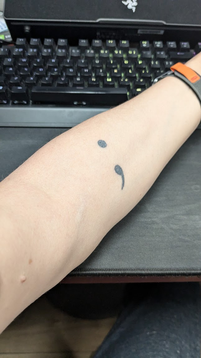 Picture of my forearm with a semicolon tattoo.