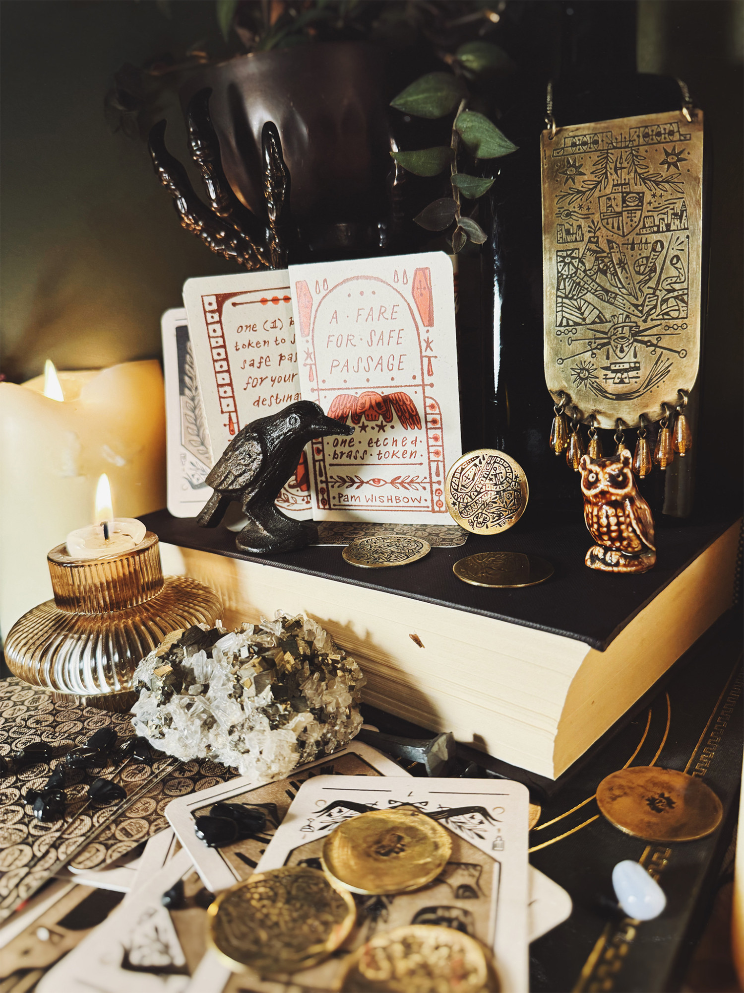 etched brass coins and pamphlet in a pile of occult themed stuff